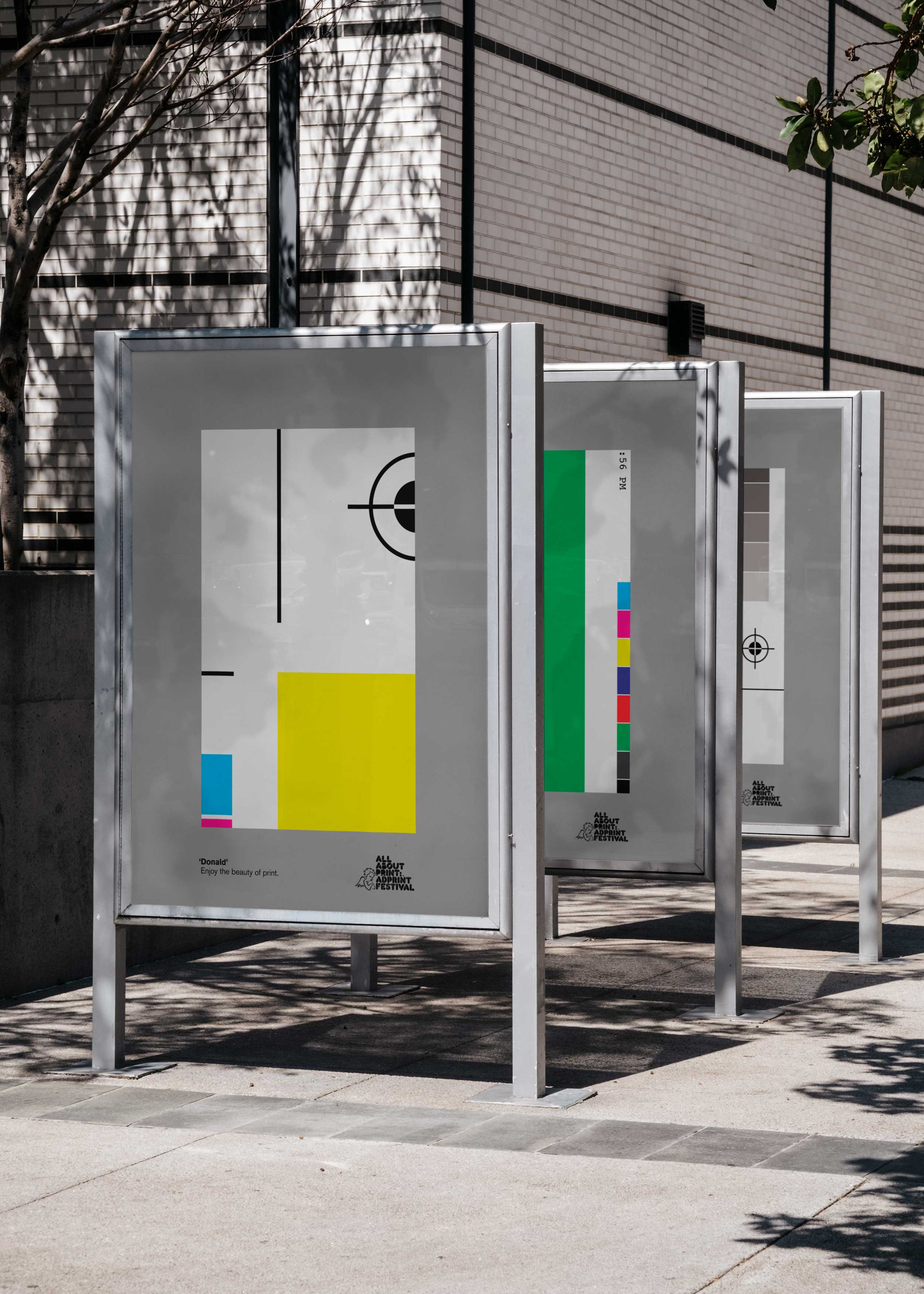 Outdoor display case showing layered AdPrint posters
