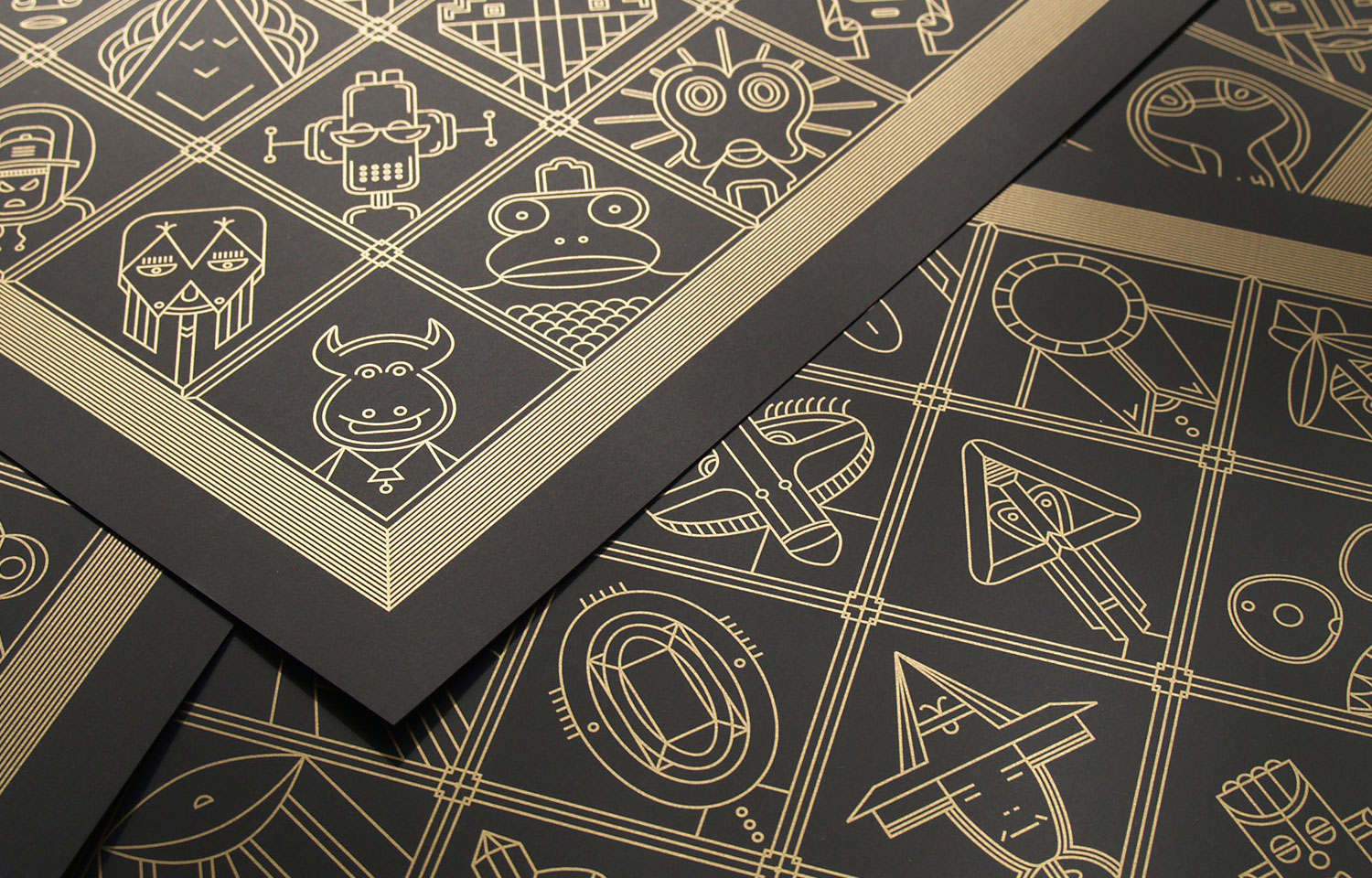 Close-up of black card deck with gold geometric illustrations