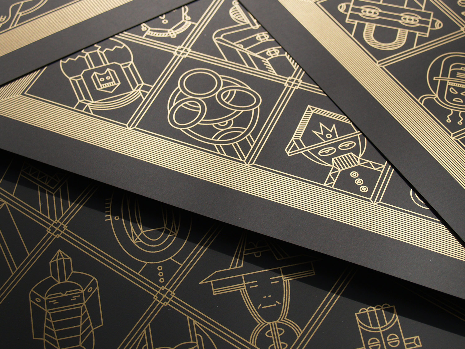 Close-up of gold geometric figures on black card