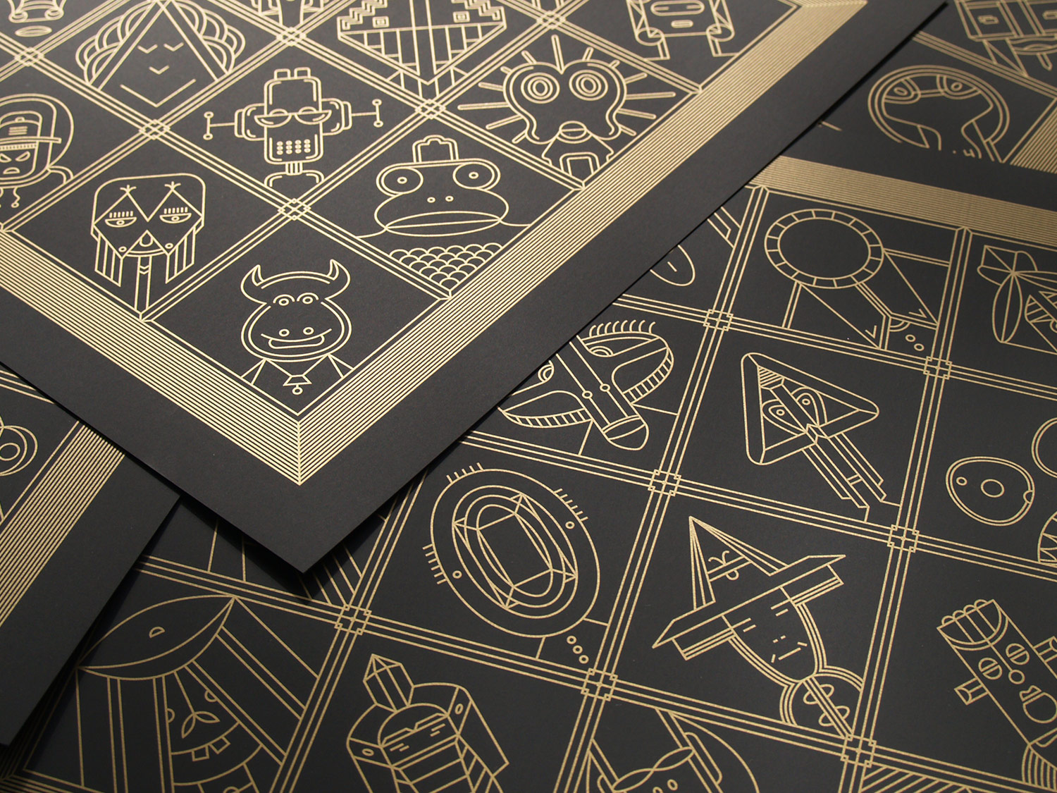 Stacked black cards printed with gold geometric figures