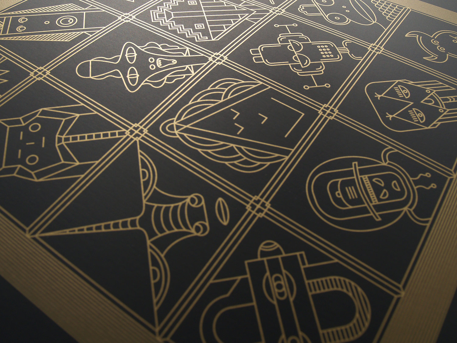 Close-up of gold geometric figures on black card