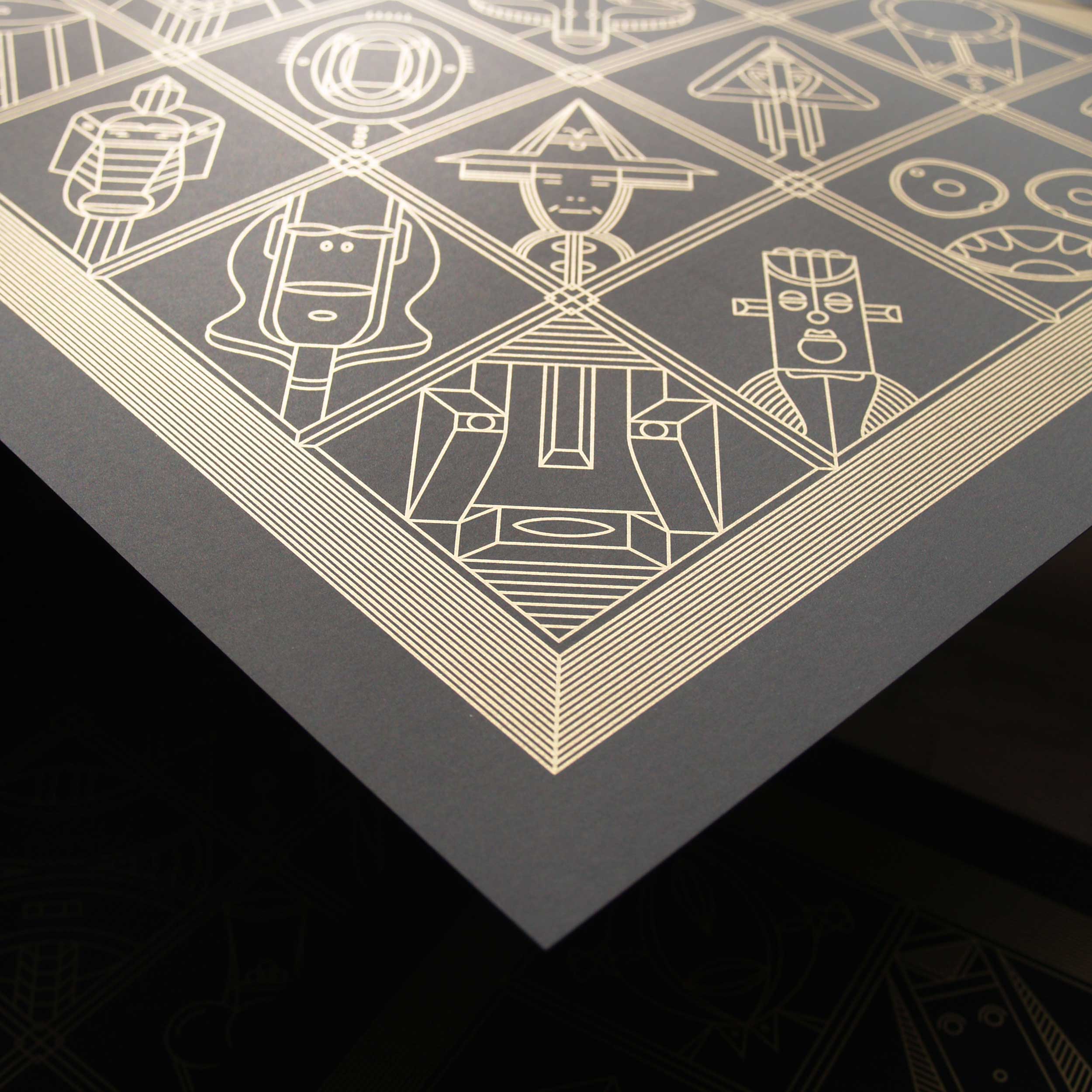 Corner of black card printed with gold geometric faces