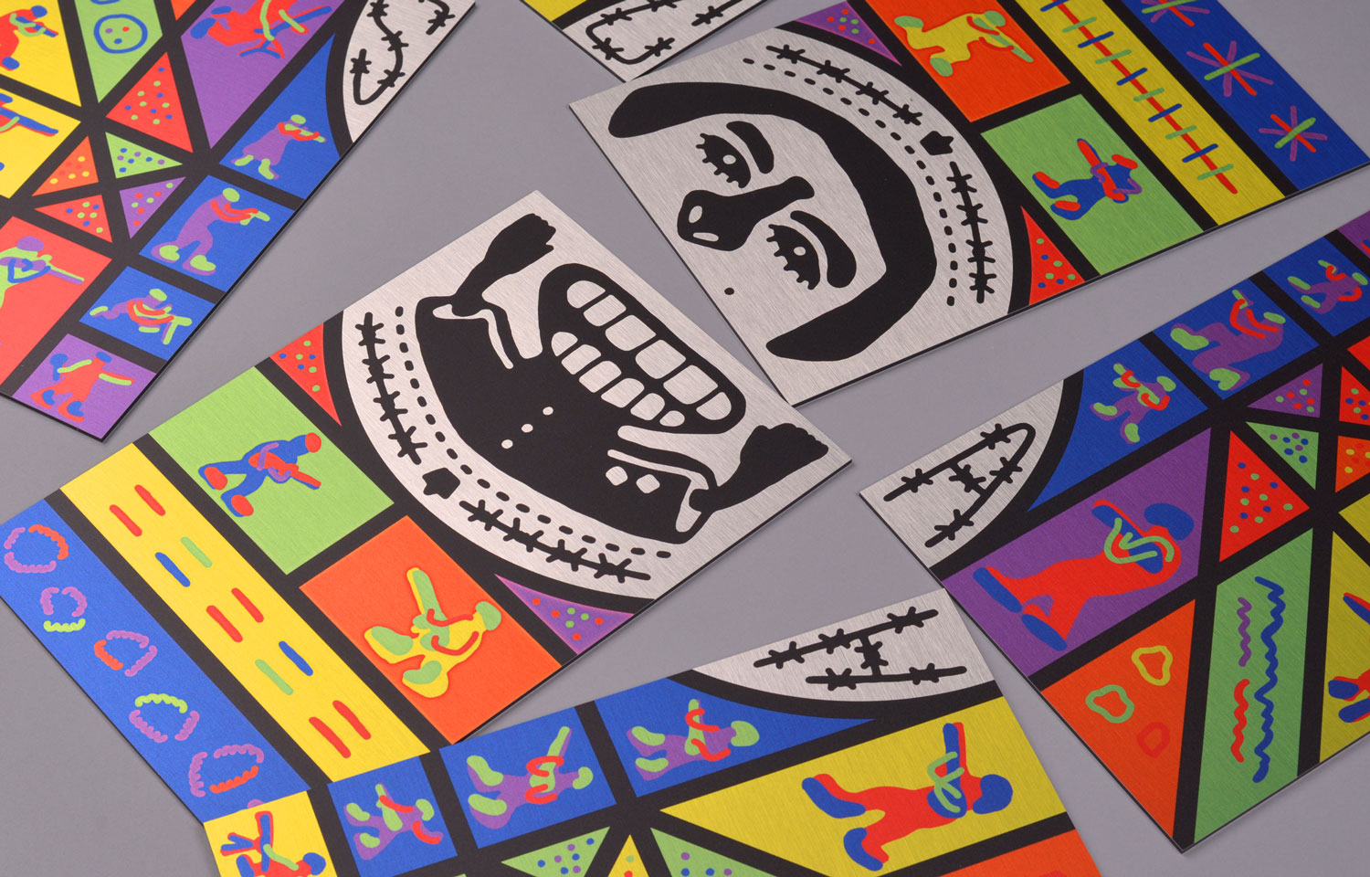 Close-up of folded colourful print featuring a stylised face