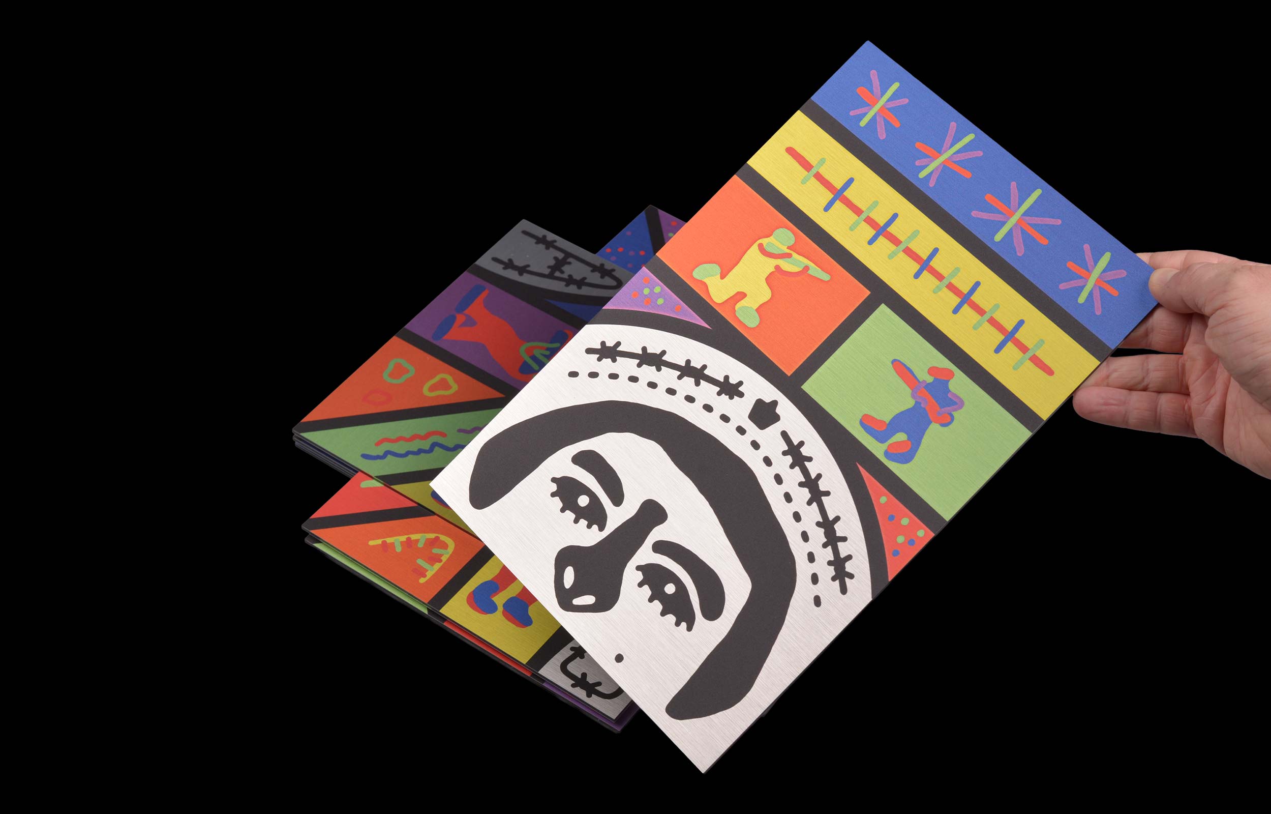 Hand holding a folded colourful Cash print