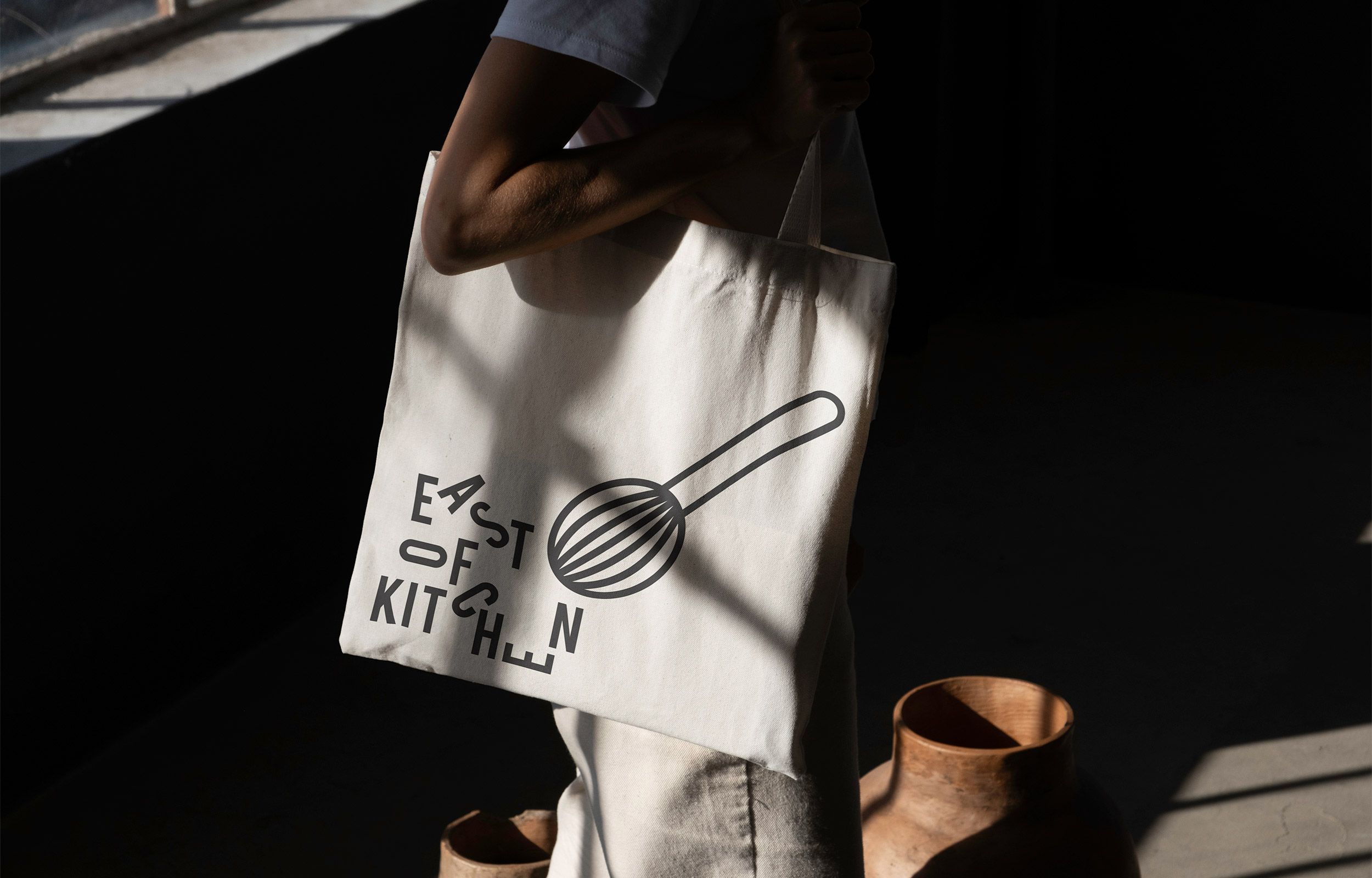 White East of Kitchen tote bag printed with a black whisk icon