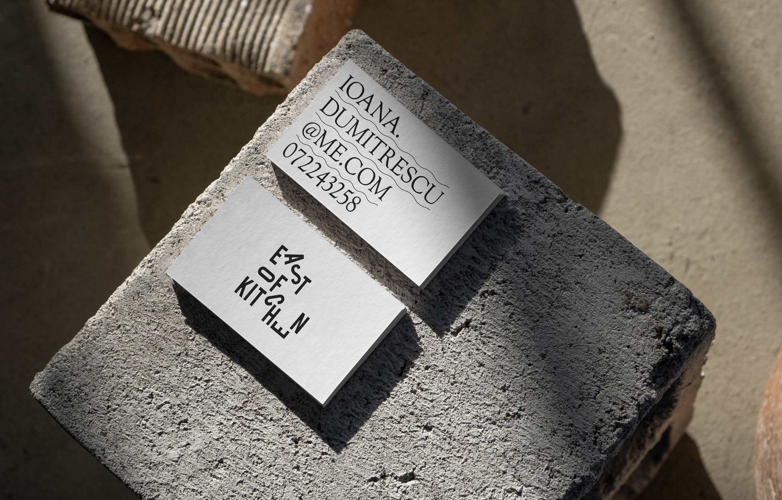 Two East of Kitchen printed recipe cards on a stone block