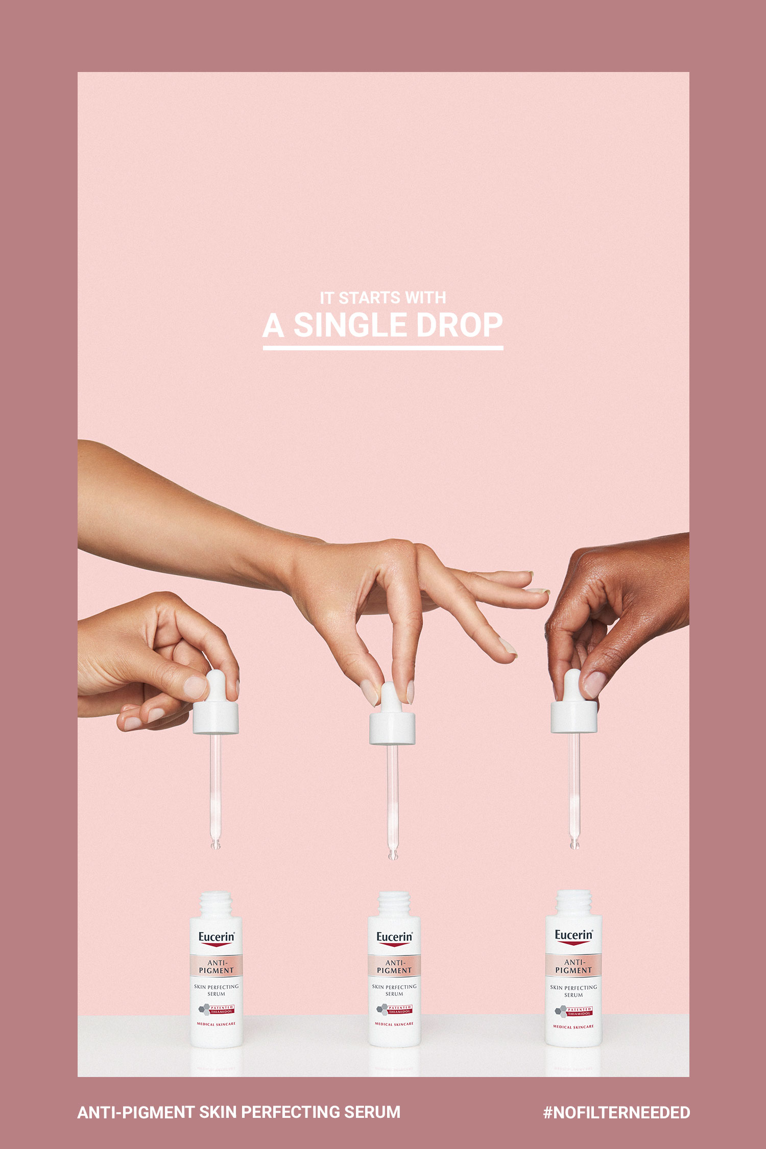 Three hands holding small Eucerin serum bottles on a pale pink background