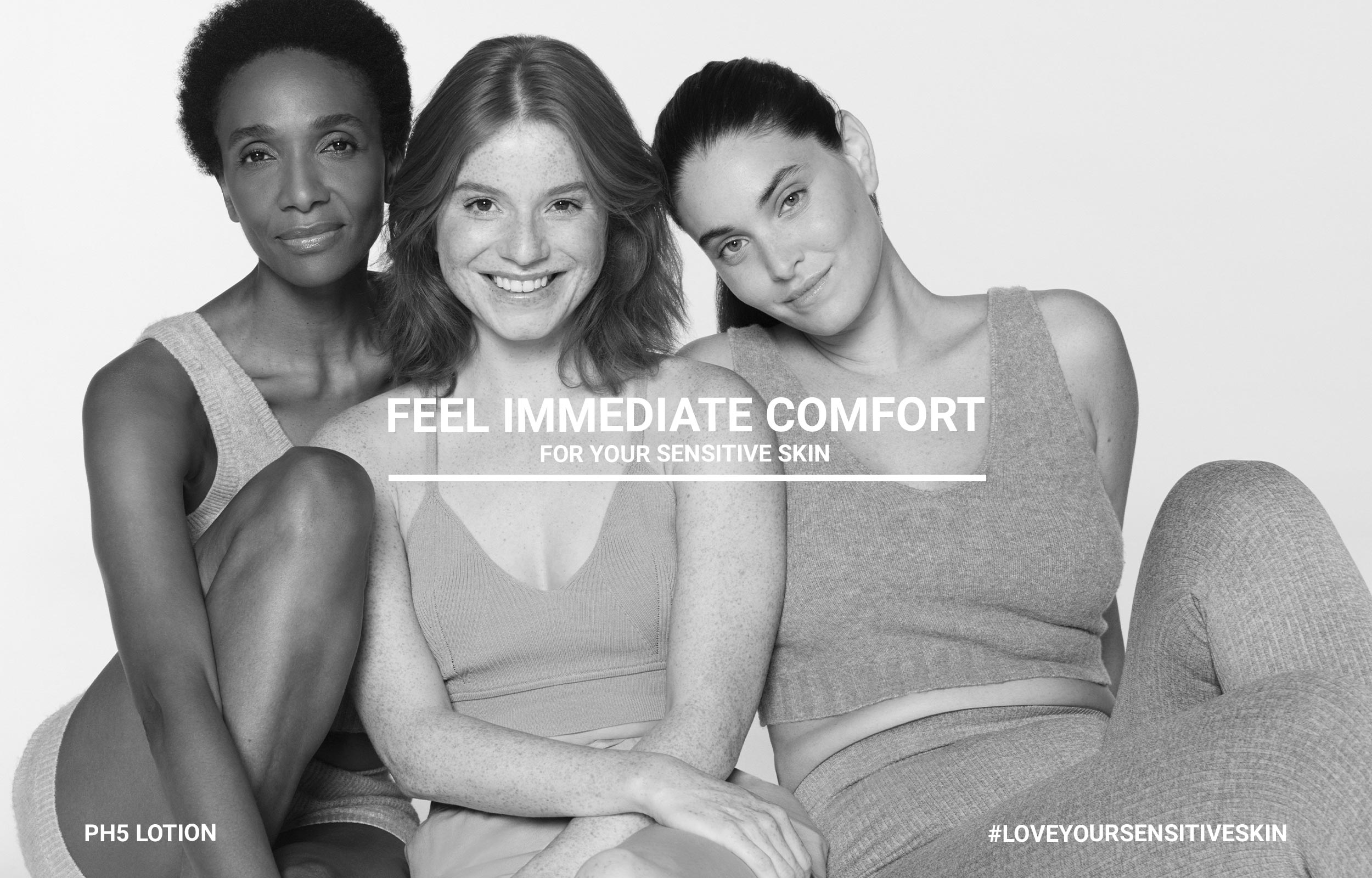 Three women seated together in a black-and-white Eucerin immediate comfort campaign