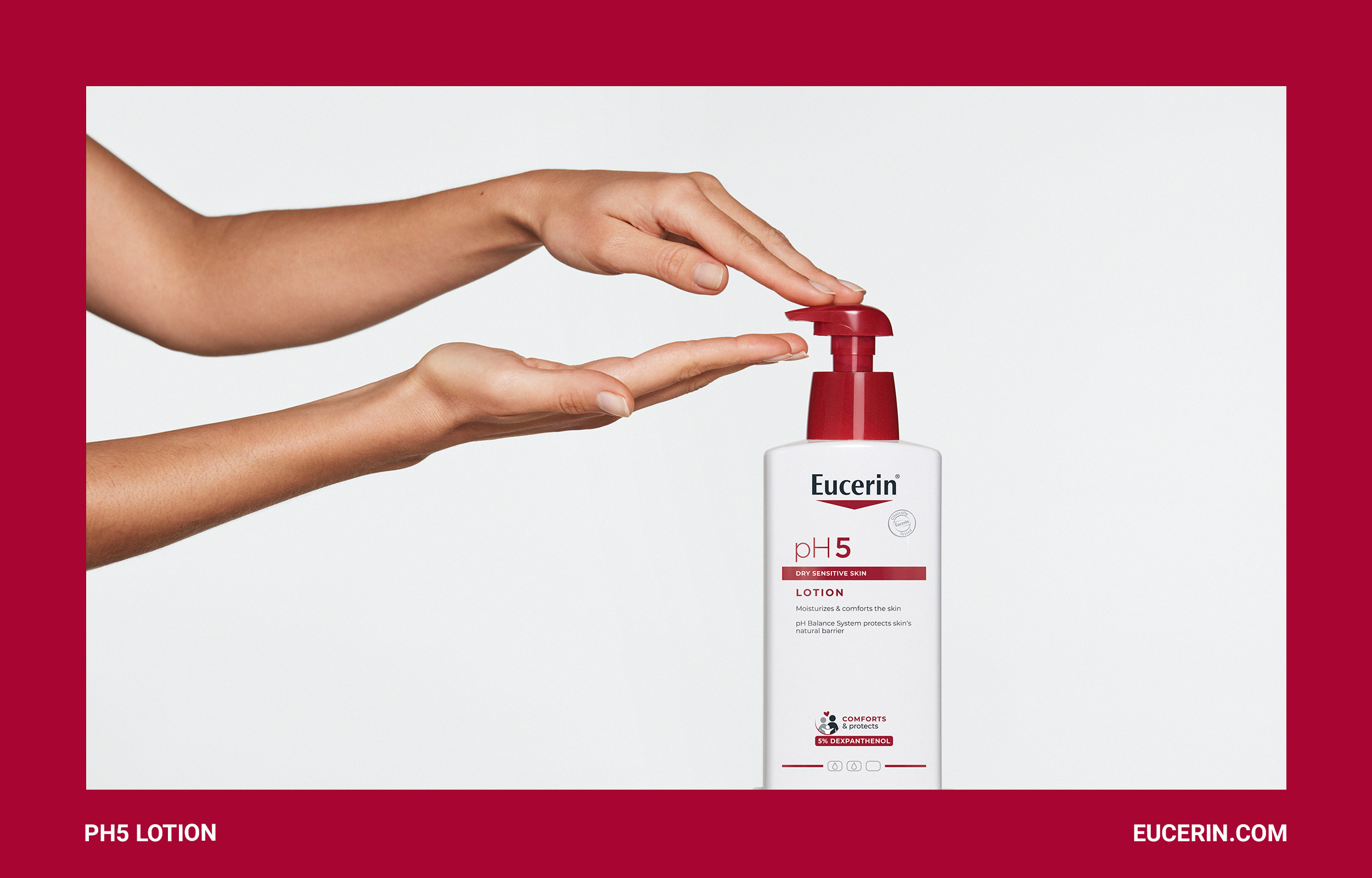Hands pressing a red-pump Eucerin lotion bottle inside a burgundy frame