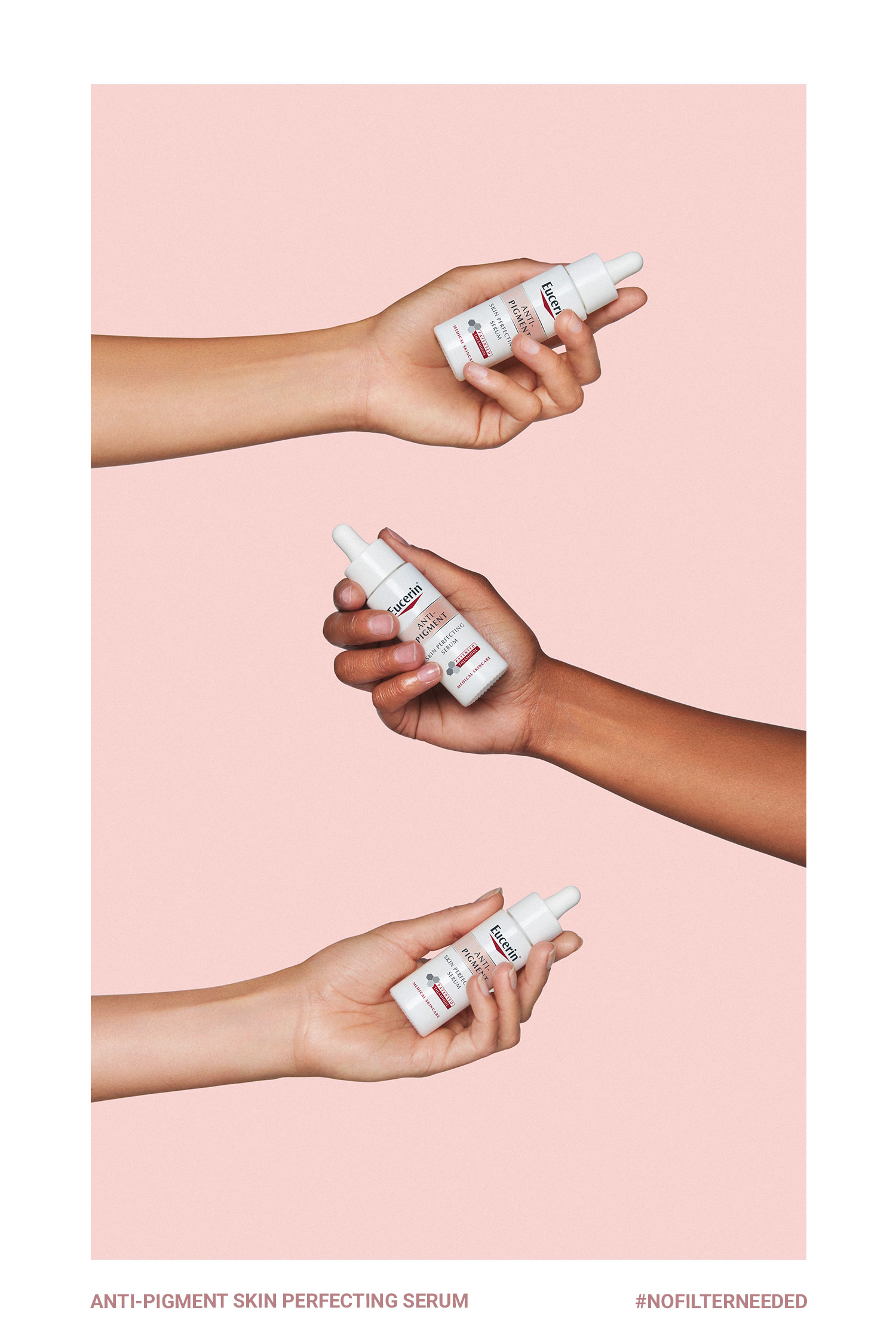 Hands holding three small Eucerin serum bottles against pale pink