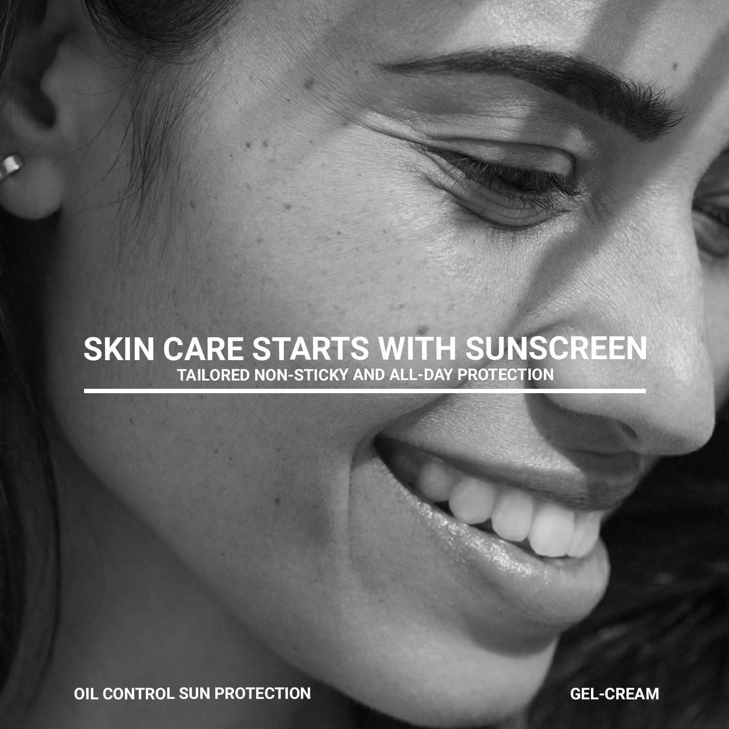 Black-and-white close-up of a smiling woman with sunscreen campaign text