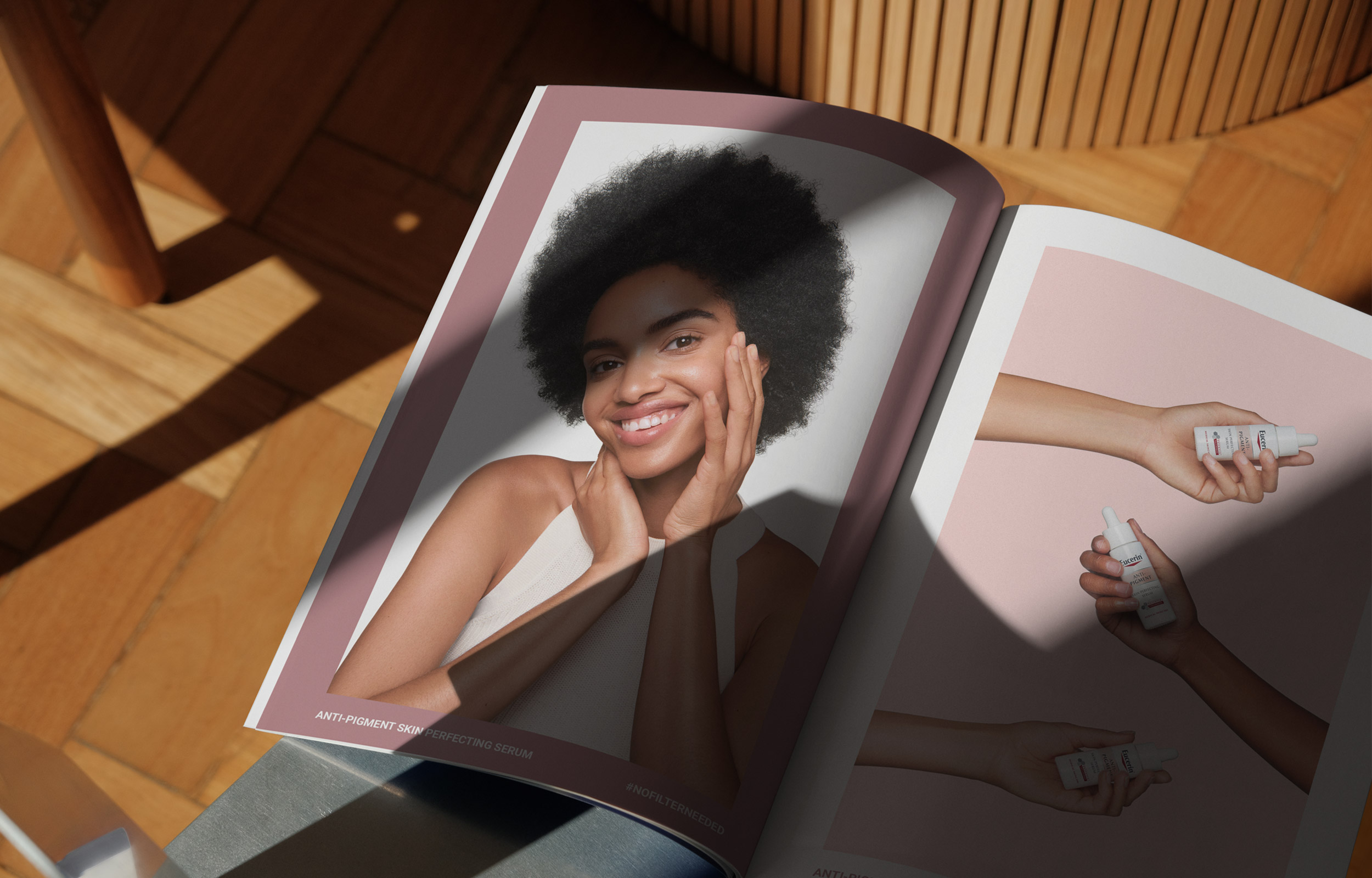 Open Eucerin campaign book showing a portrait spread on a wooden chair