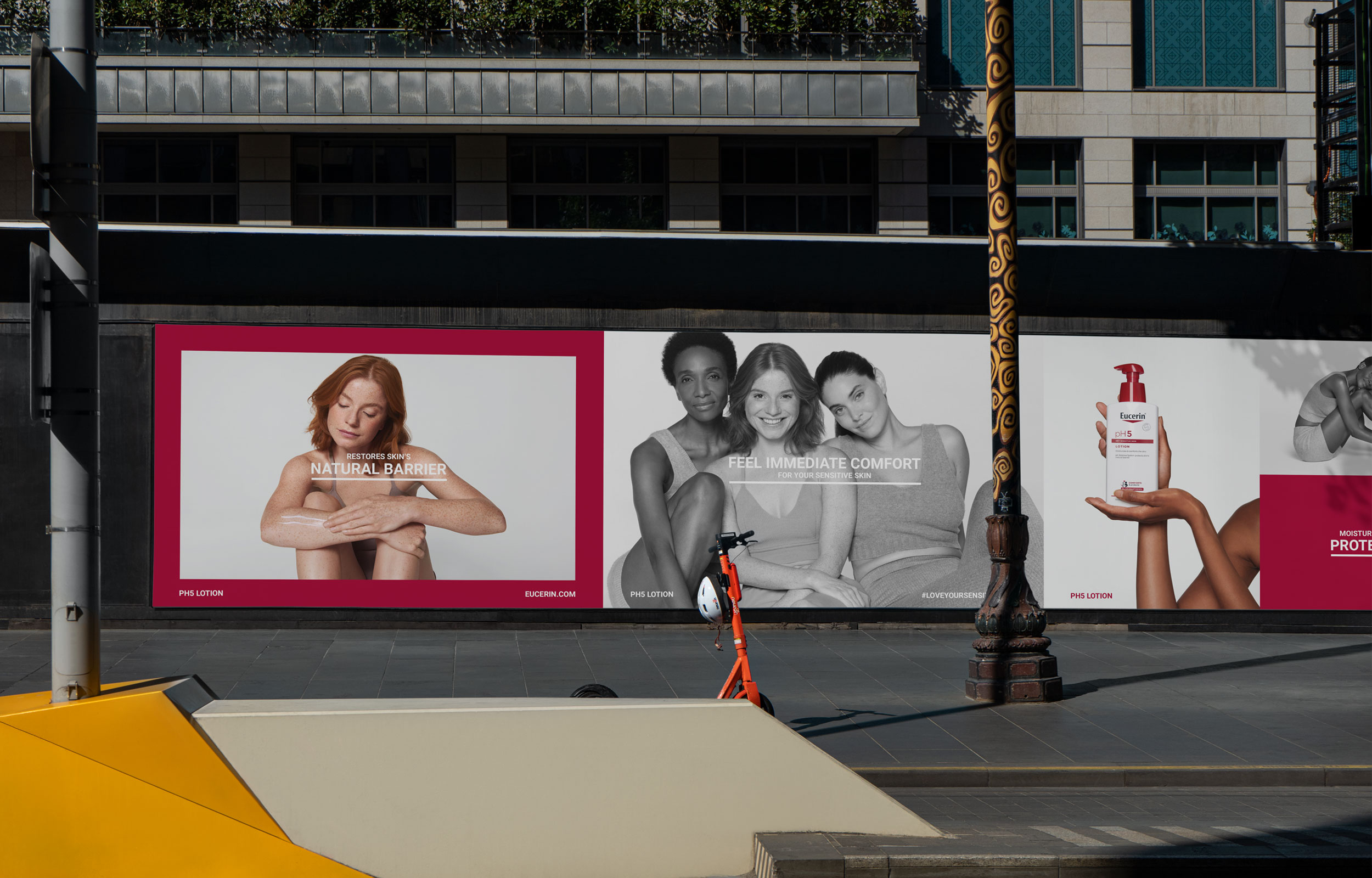 Two large Eucerin campaign posters displayed on a city street wall
