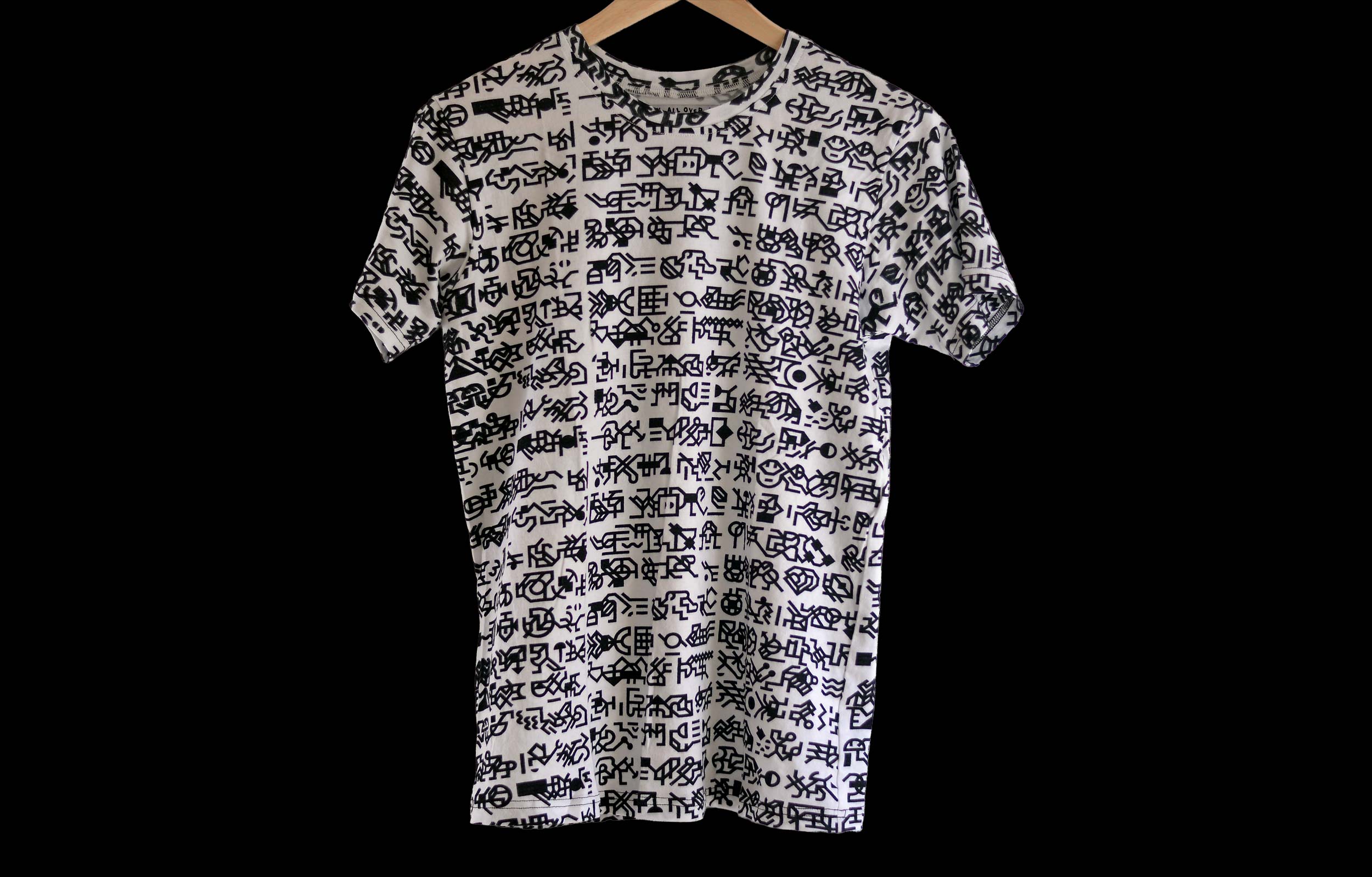 White T-shirt covered in a black geometric glyph pattern