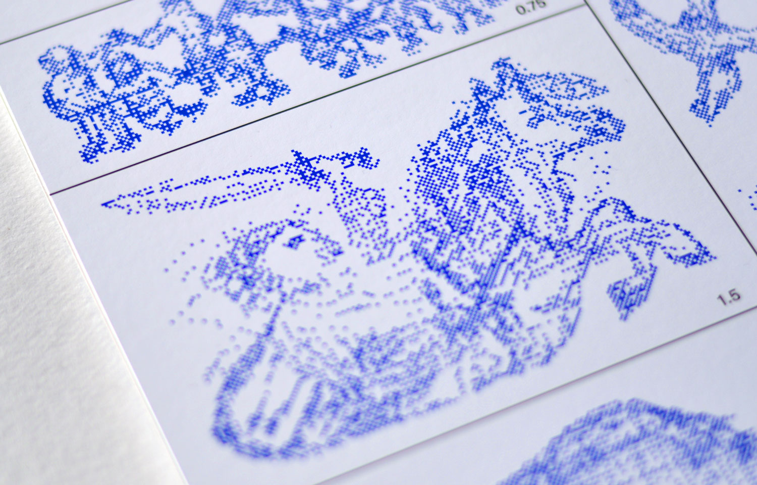 Close-up of a blue dotted illustration sheet showing figures and landscape forms
