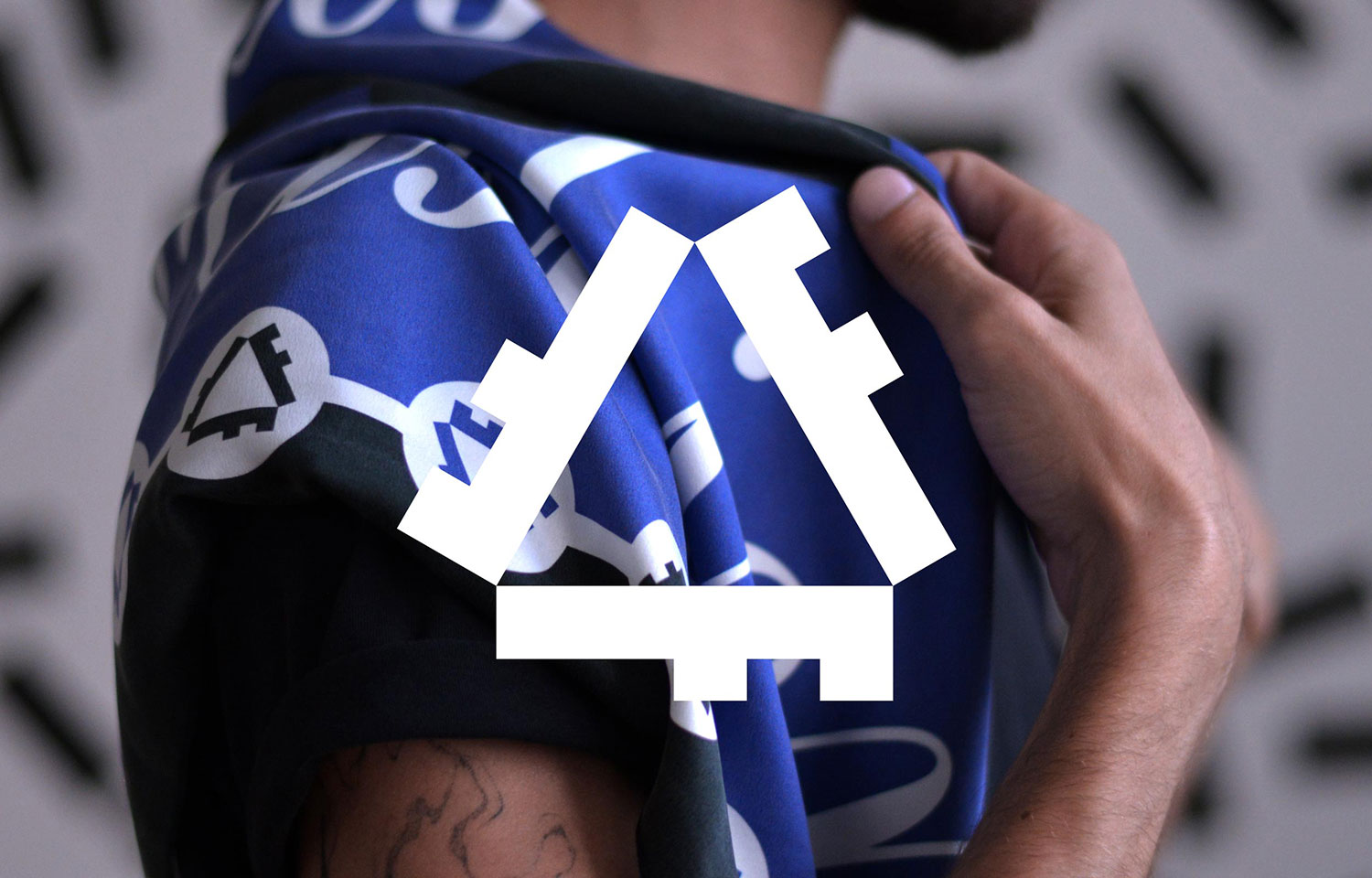 Person wearing a blue-and-white Fuck Fast Fashion scarf