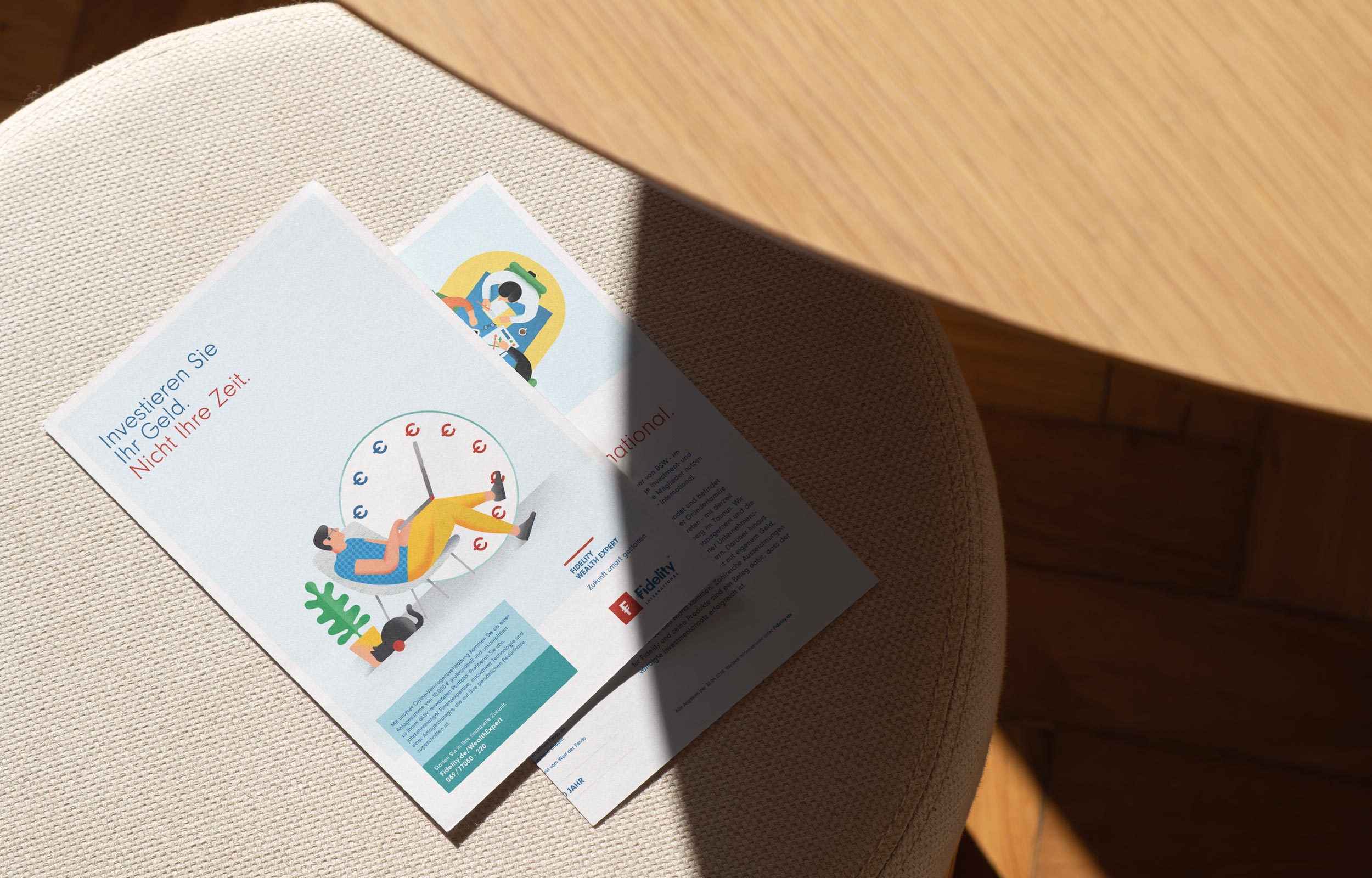 Fidelity printed brochures and cards laid across a round table