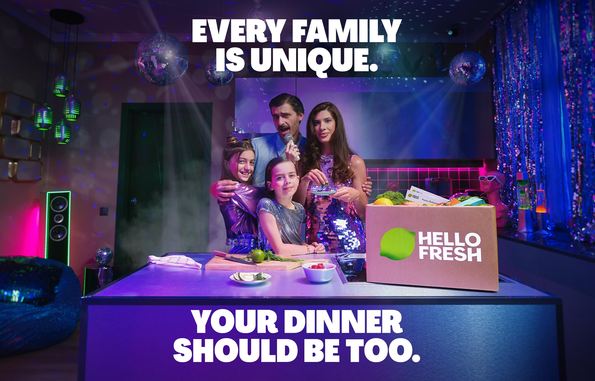 Family dining in a neon-lit room beside a HelloFresh box