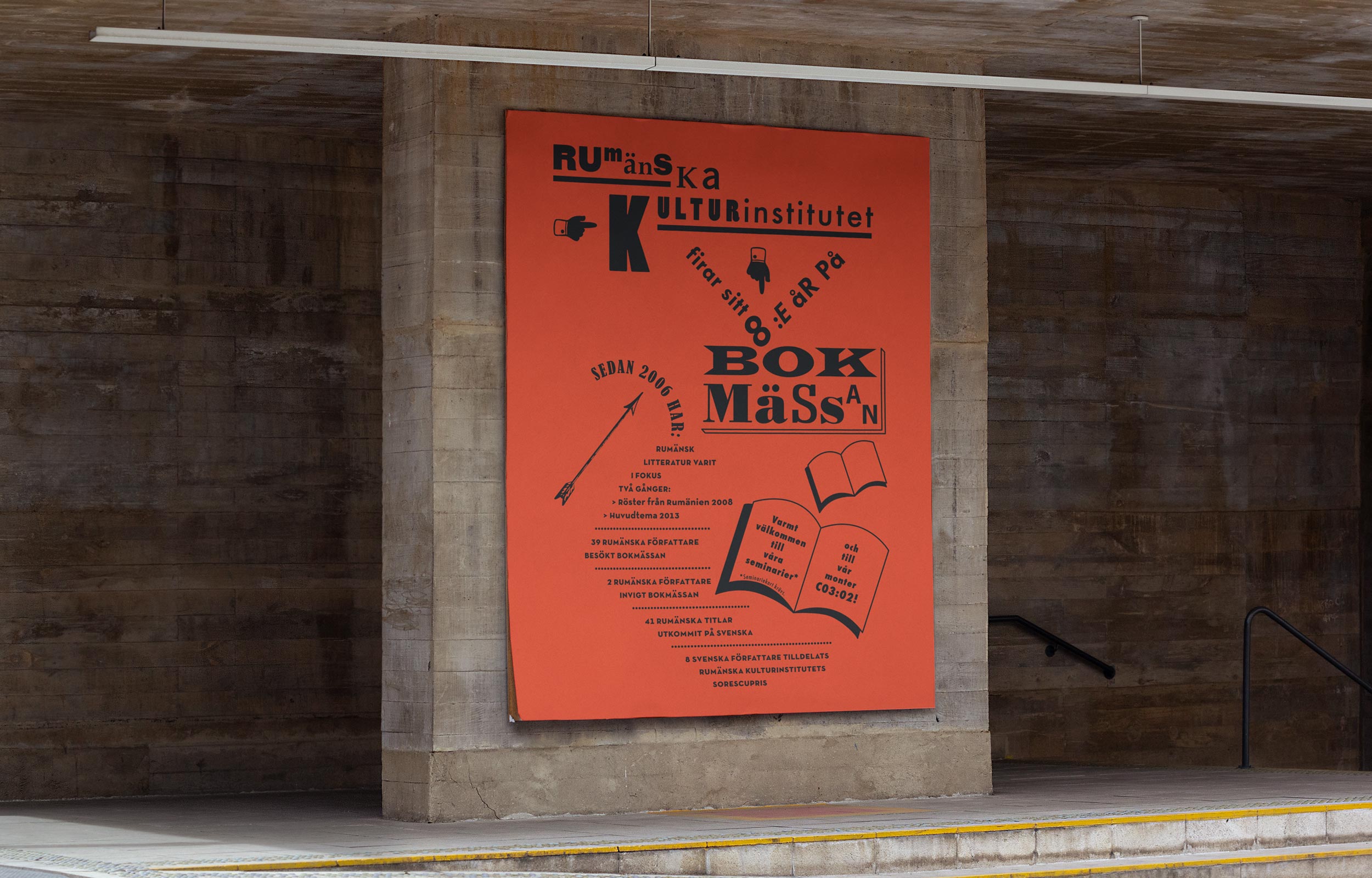 Orange book fair poster mounted inside a stone-walled exhibition alcove