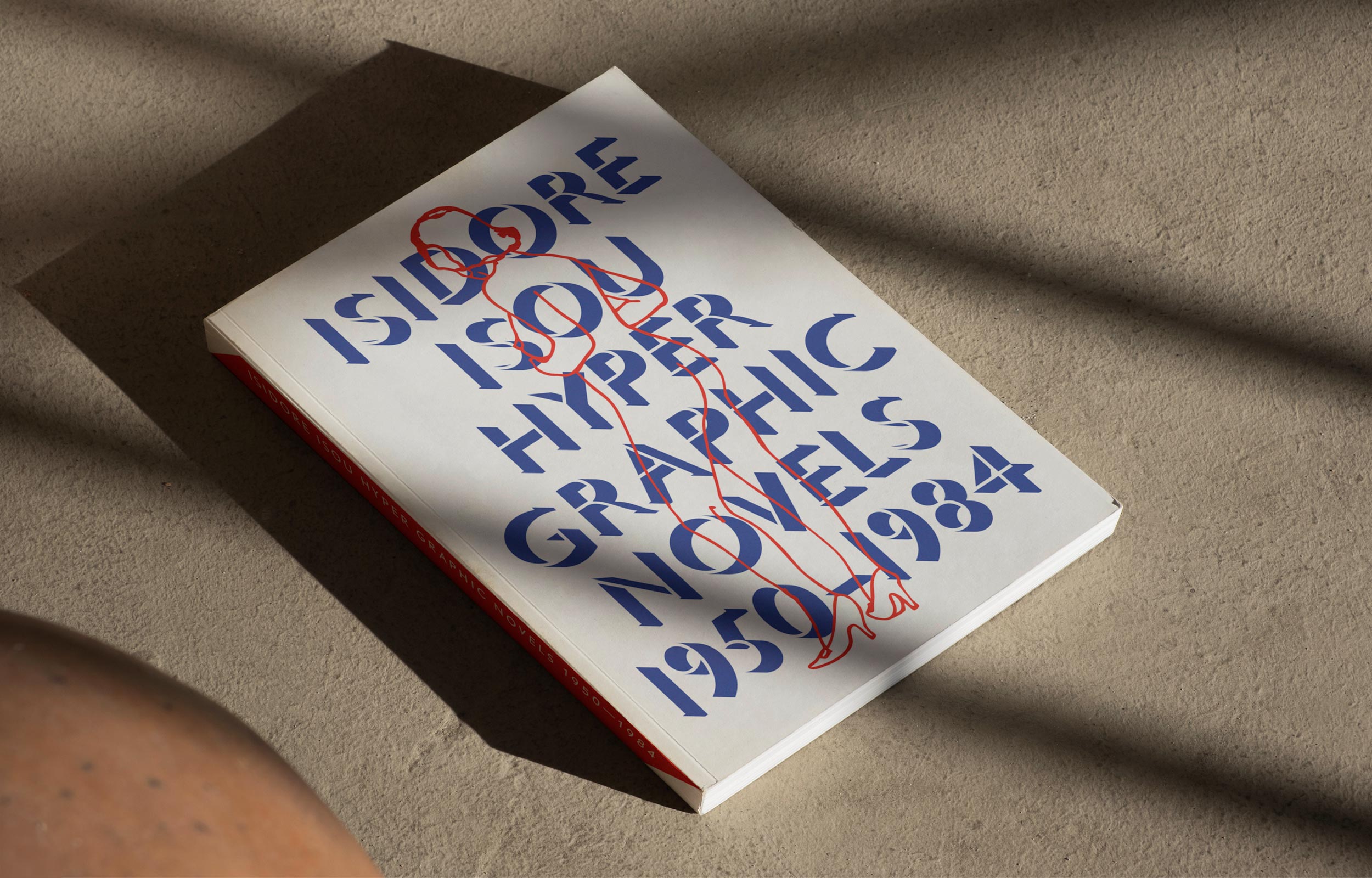 White Isidore Isou exhibition book lying on a sunlit surface