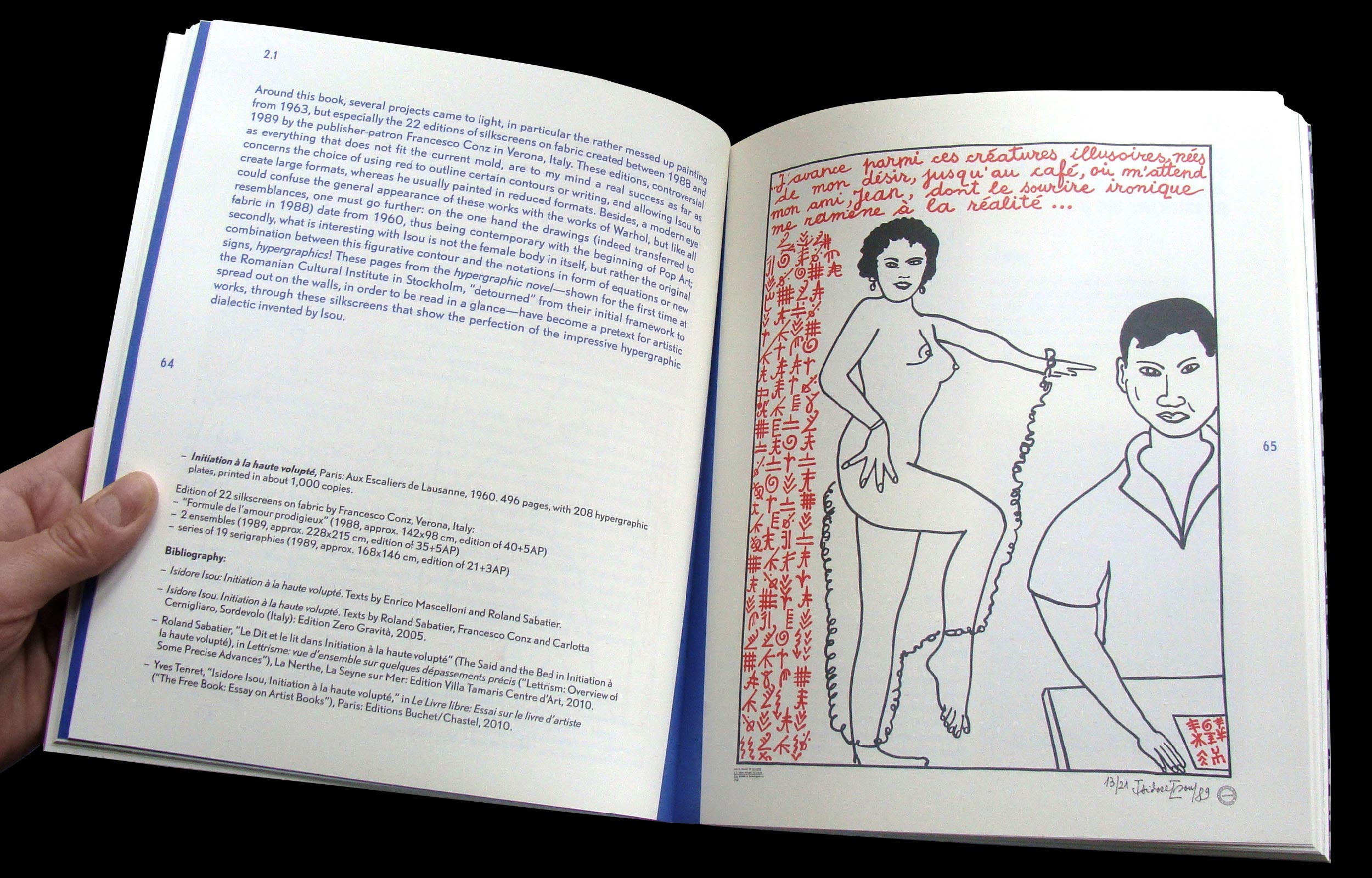 Hands holding an open book with text and a red-and-black line drawing of two figures
