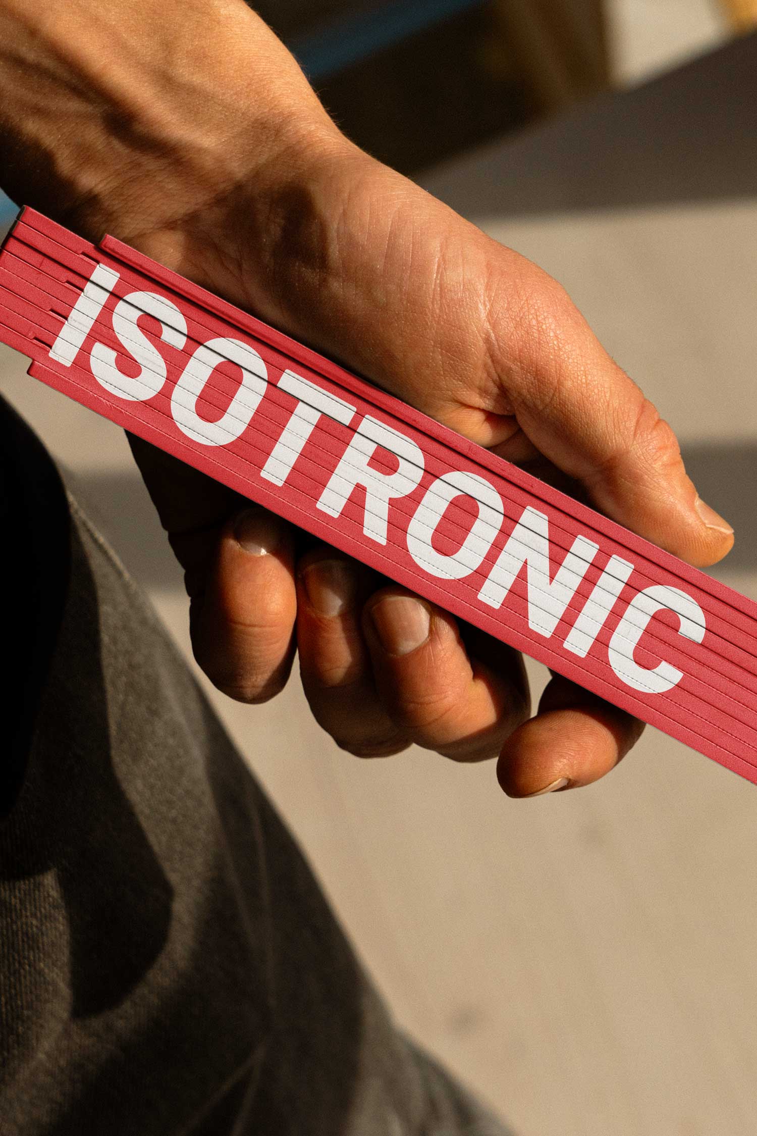 Hand holding a stack of red Isotronic branded cards