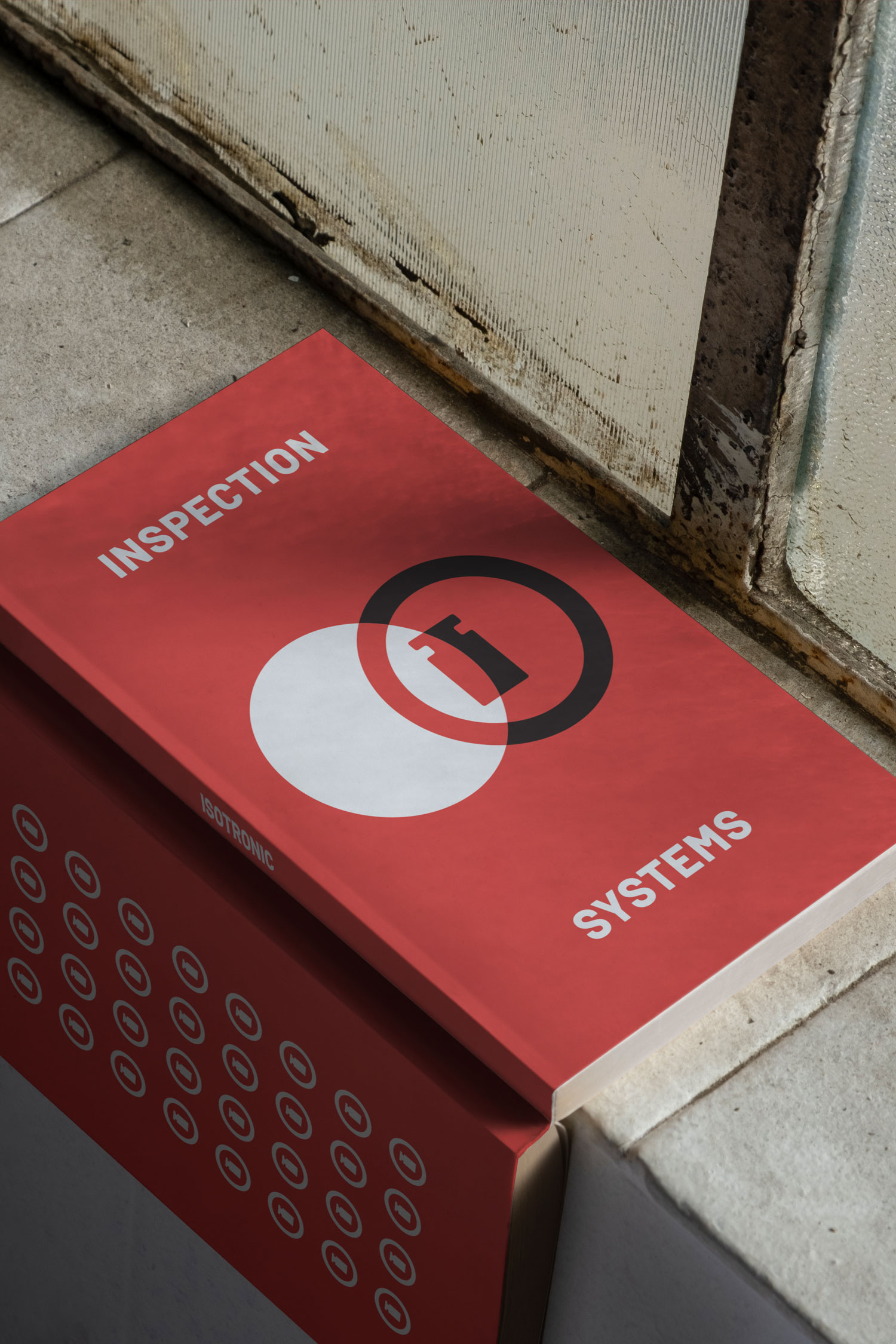Red Isotronic inspection systems brochure tucked into a doorway