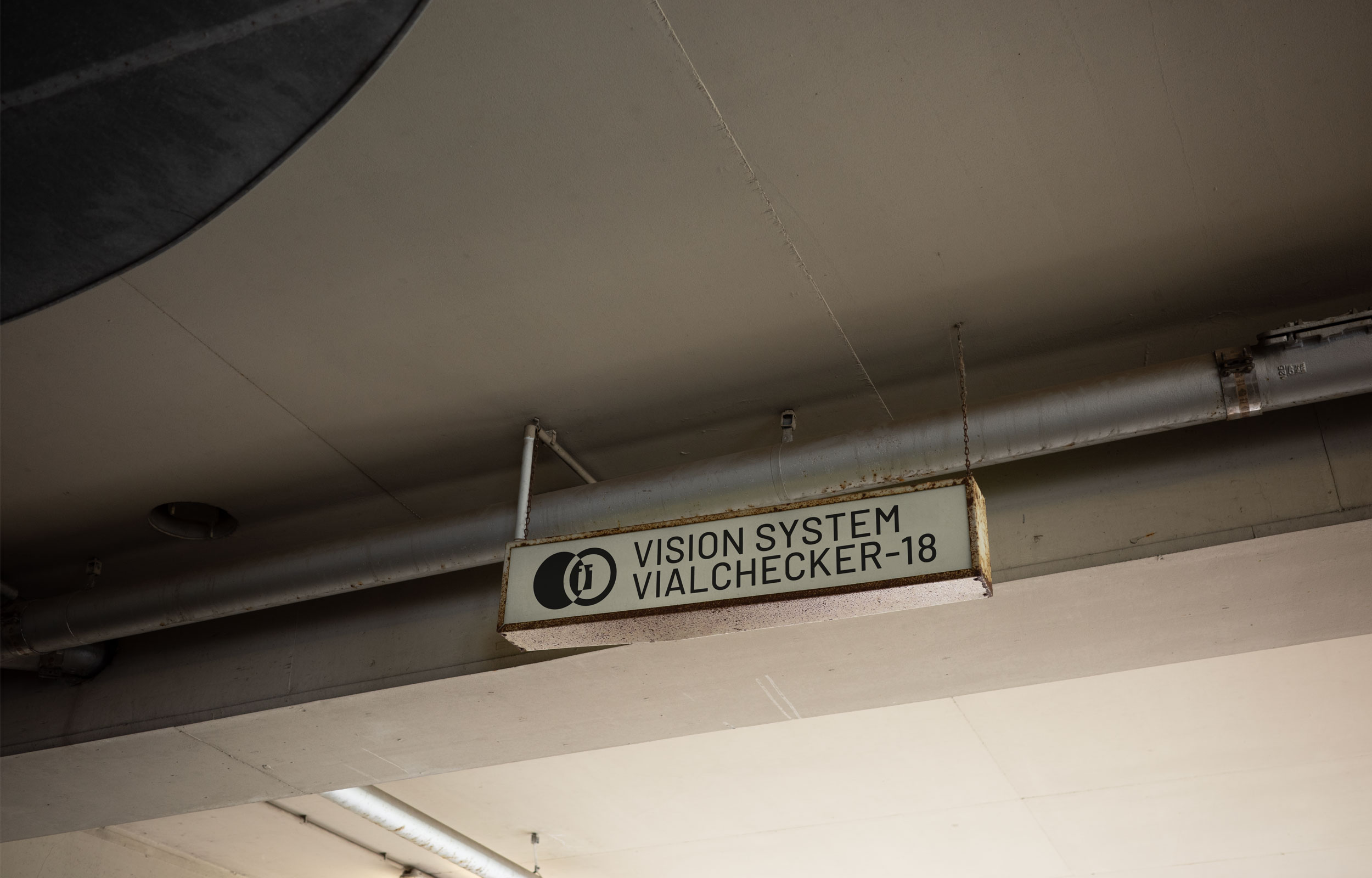 Underside of a building with a small Isotronic Vision Systems sign