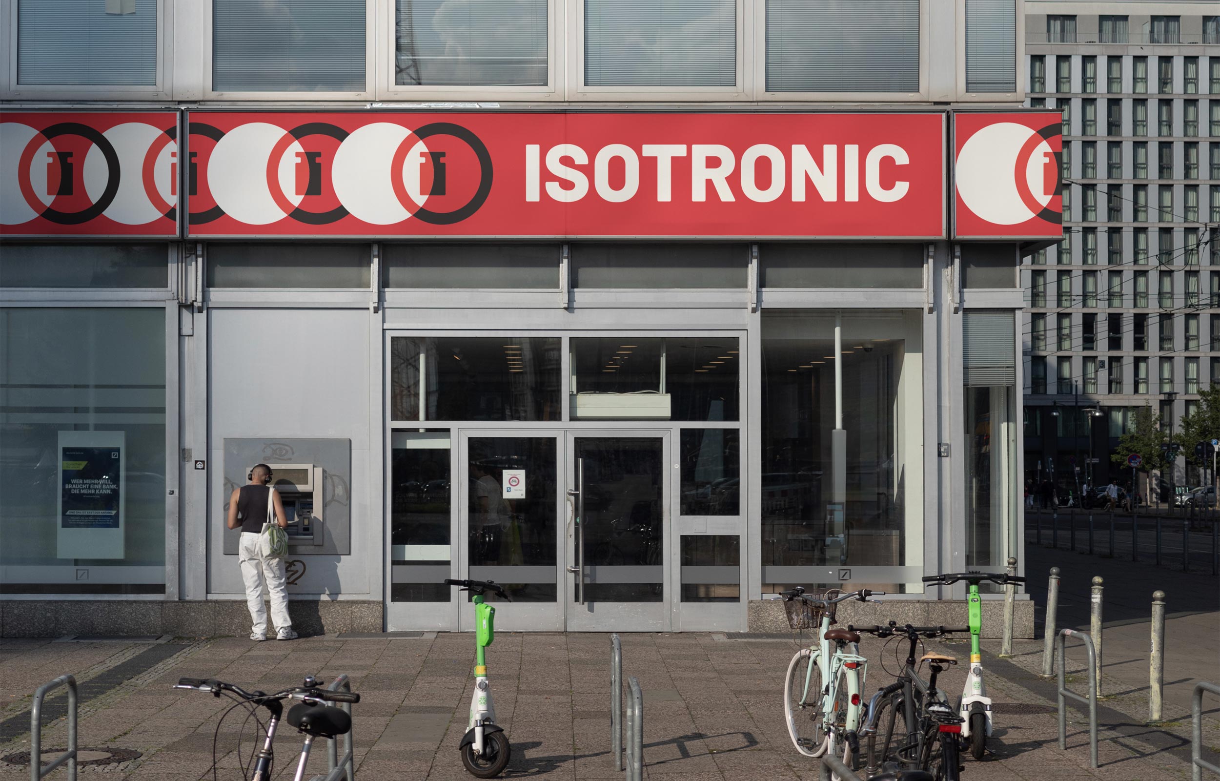Building entrance with large red Isotronic sign spanning the facade