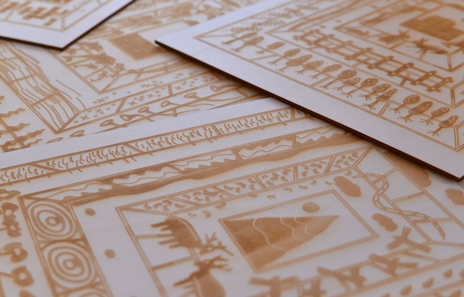Close-up of overlapping white cards printed with gold illustrated borders