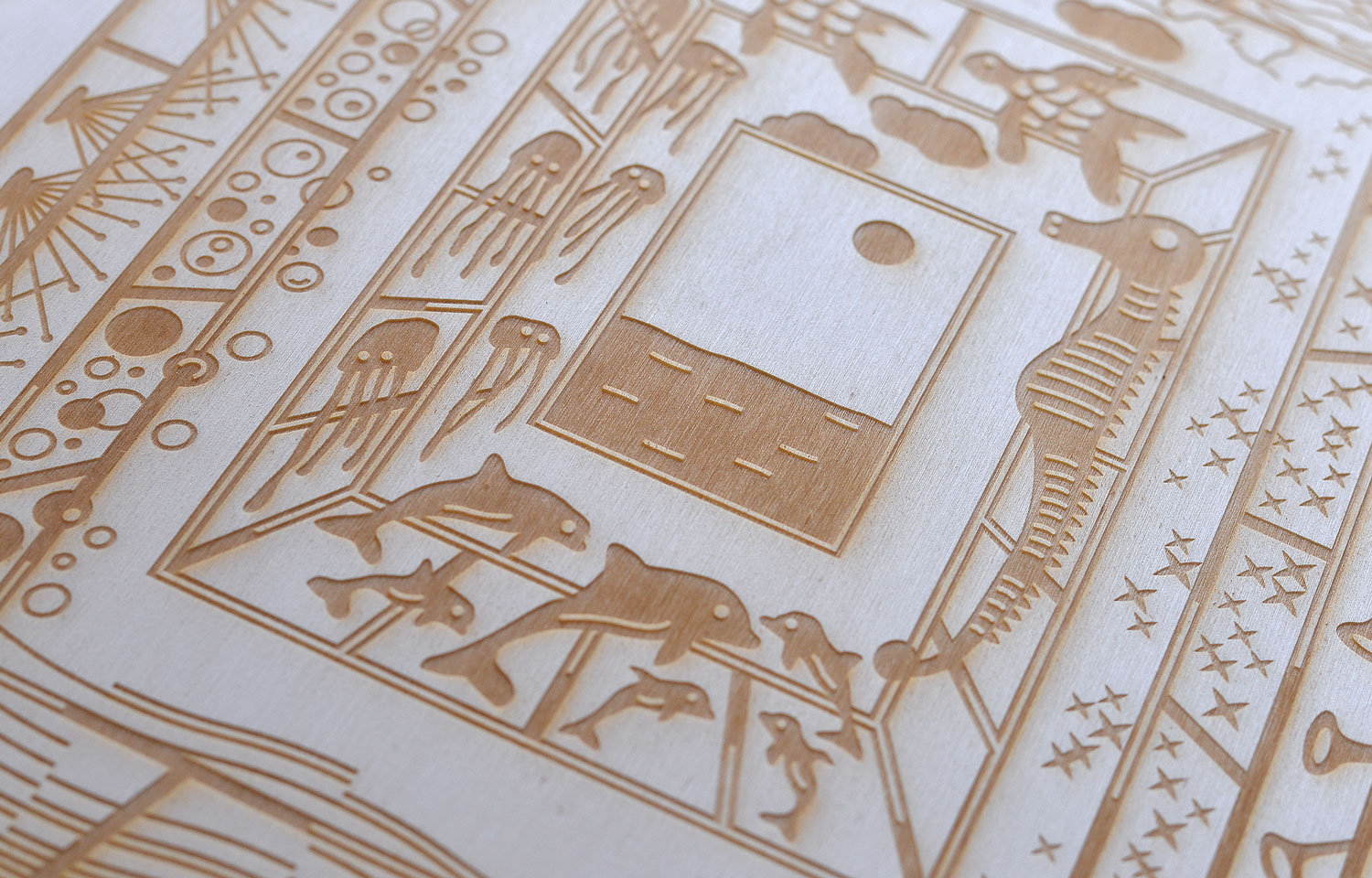 Close-up of a gold line-printed card with a central square motif