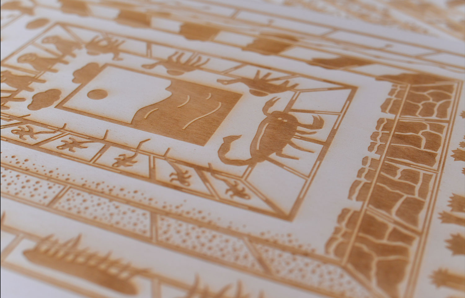 Close-up of a white card printed with a gold geometric illustrated frame