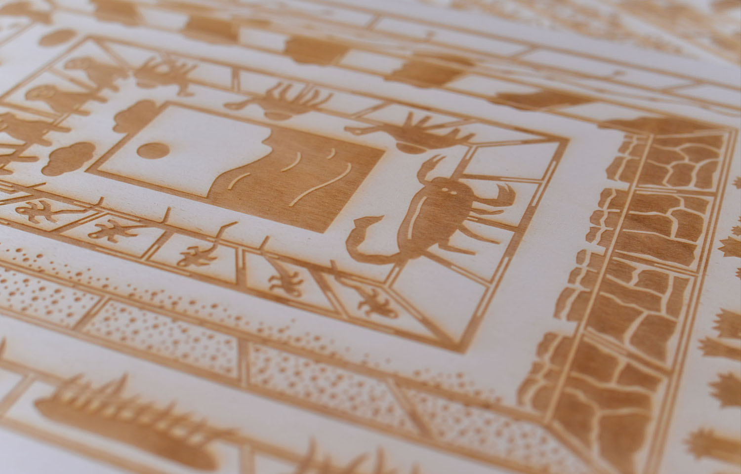 Close-up of a white card printed with a gold geometric illustrated frame