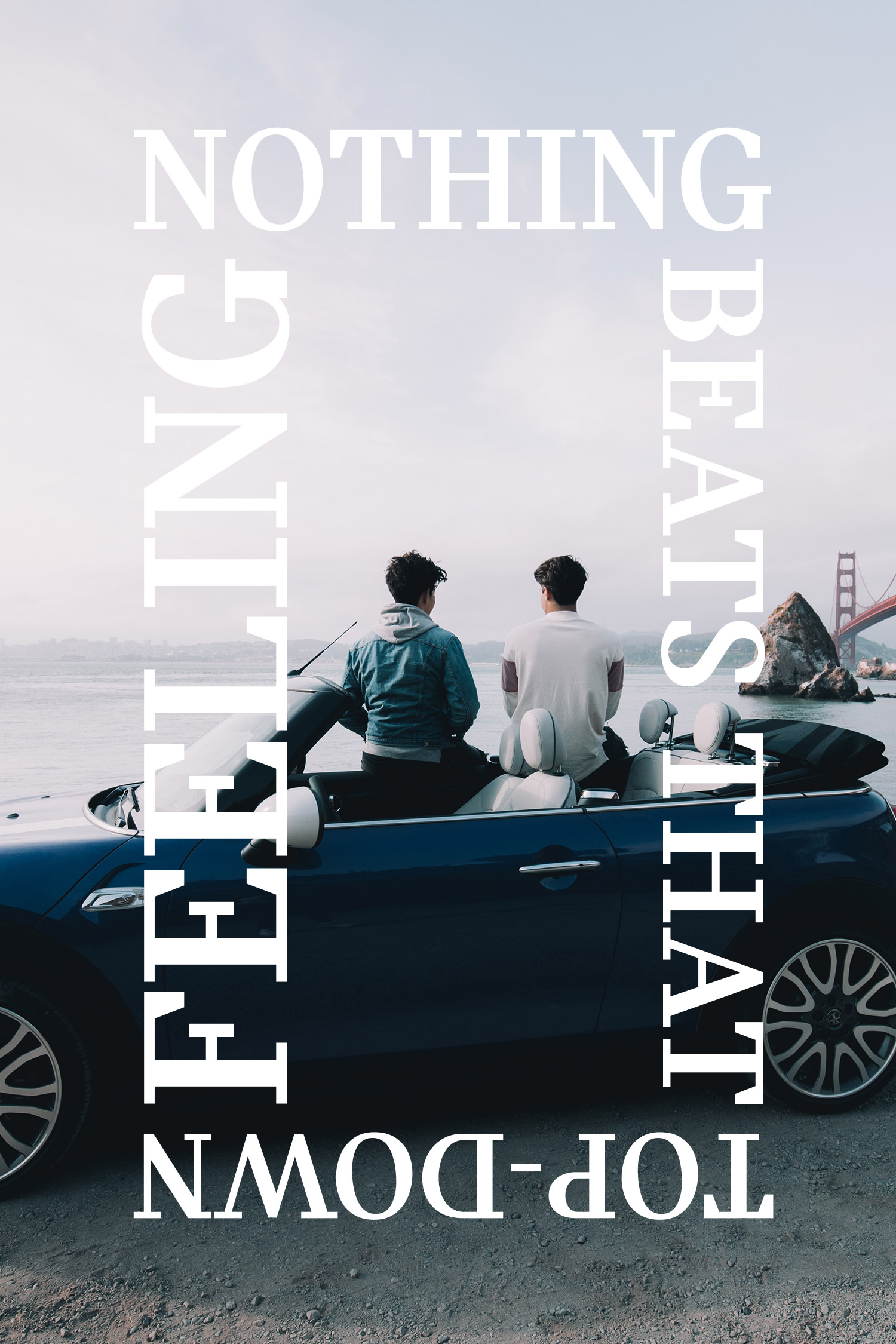 Two people seated on a car near the coast with large rotated white text