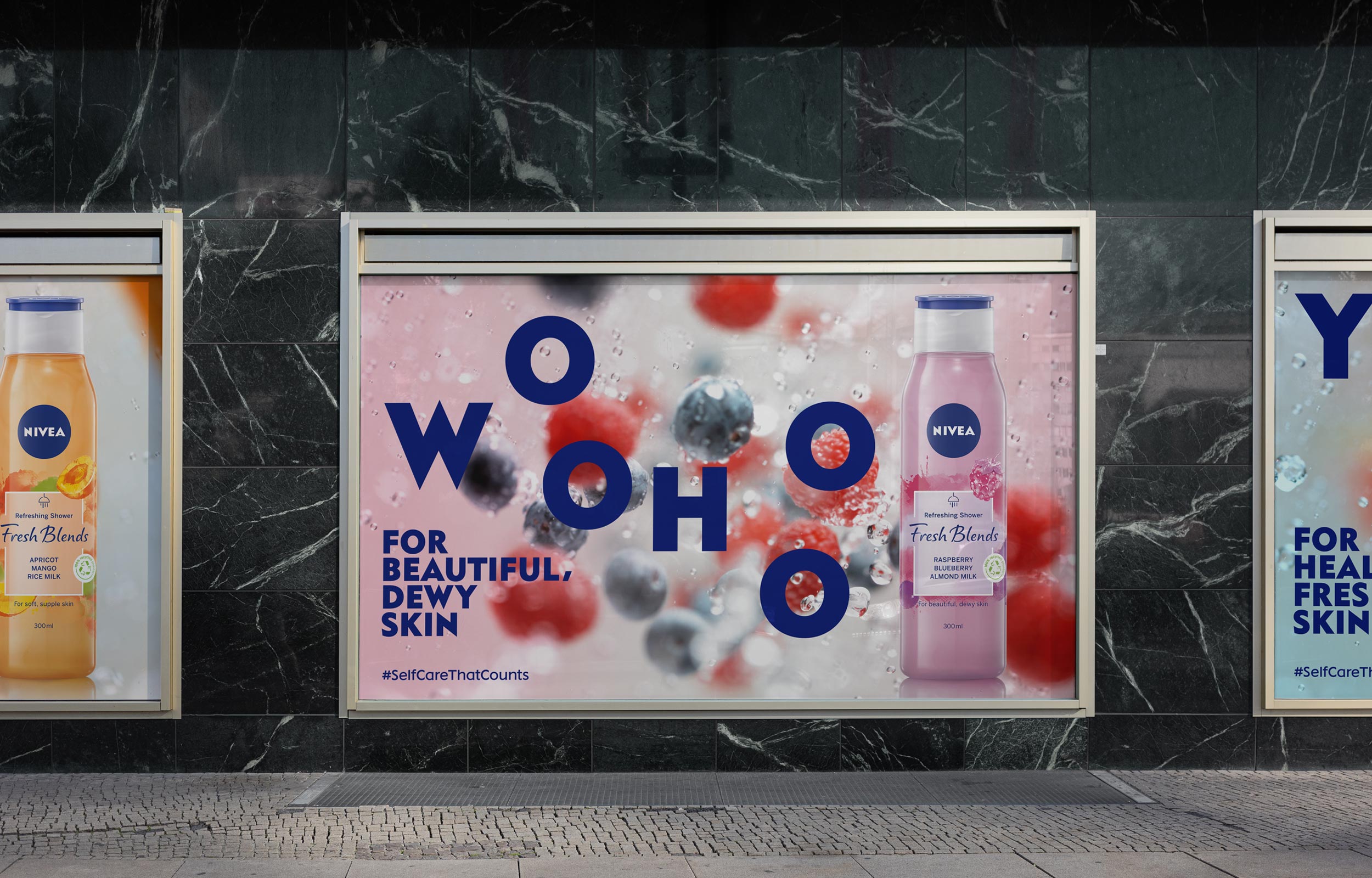 Large Nivea berry campaign billboard mounted on a dark stone wall