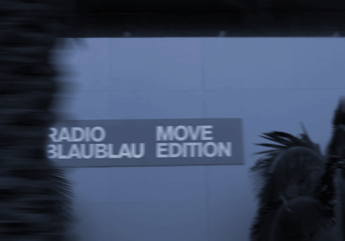 Blurred roadside Radio Blau Blau Move Edition sign at dusk