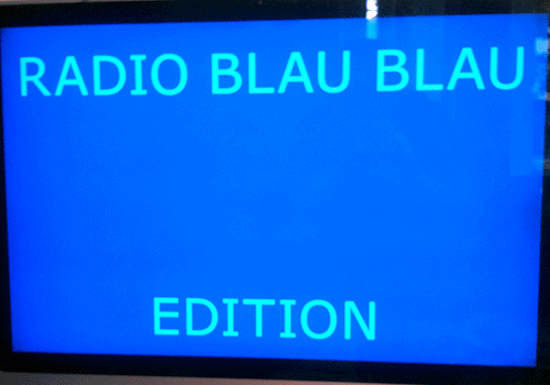 Blue illuminated display reading Radio Blau Blau Edition