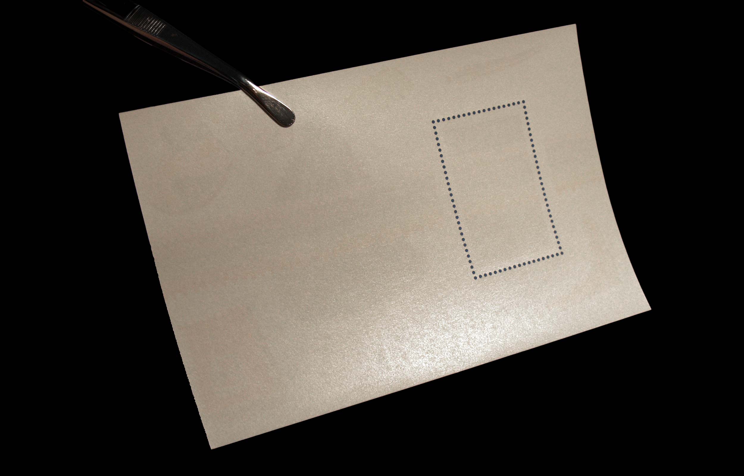 Back of a cream postcard with a dotted address rectangle