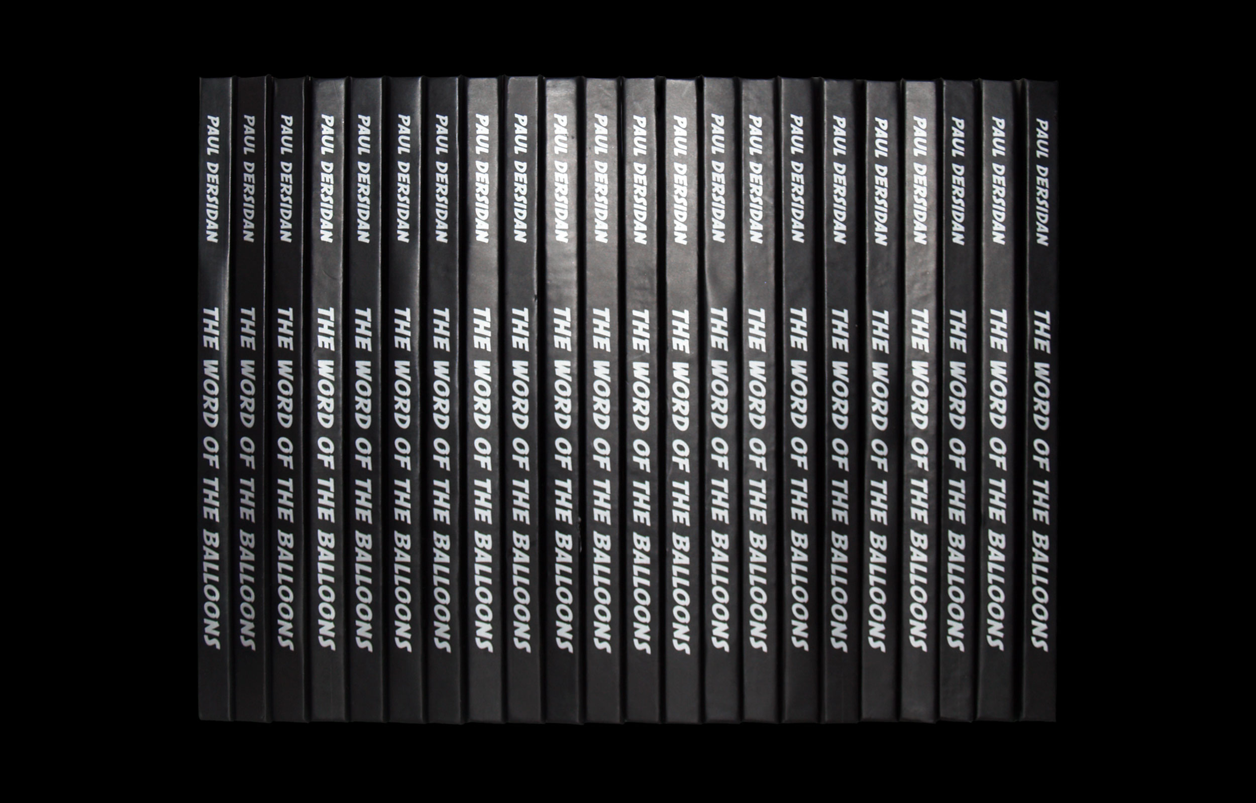 Neat row of black book spines with white title lettering