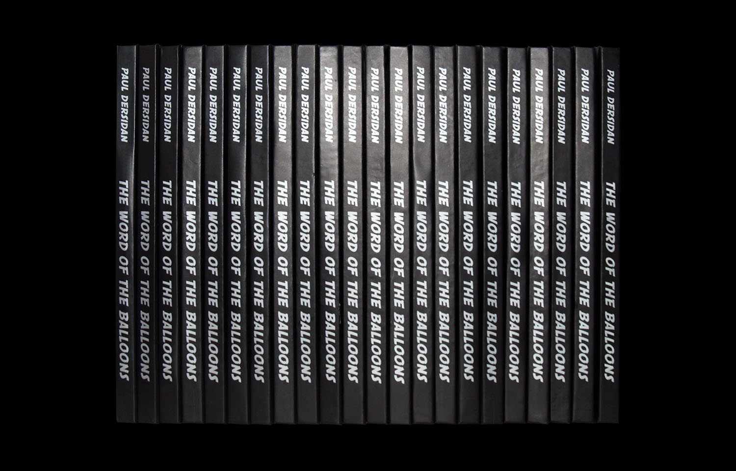 Row of black book spines with white balloon graphics