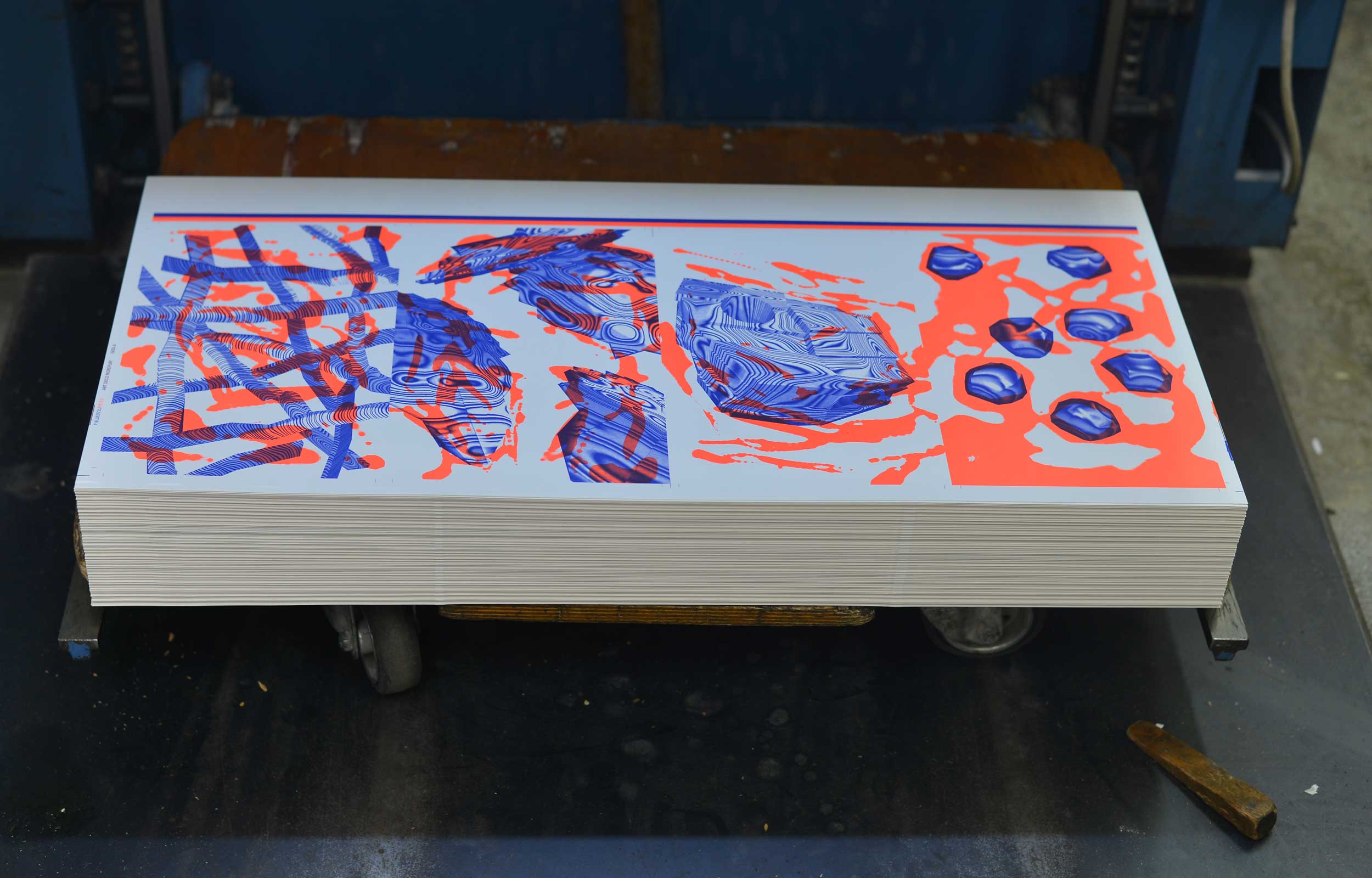 Freshly printed red and blue sheet on a screen-printing press