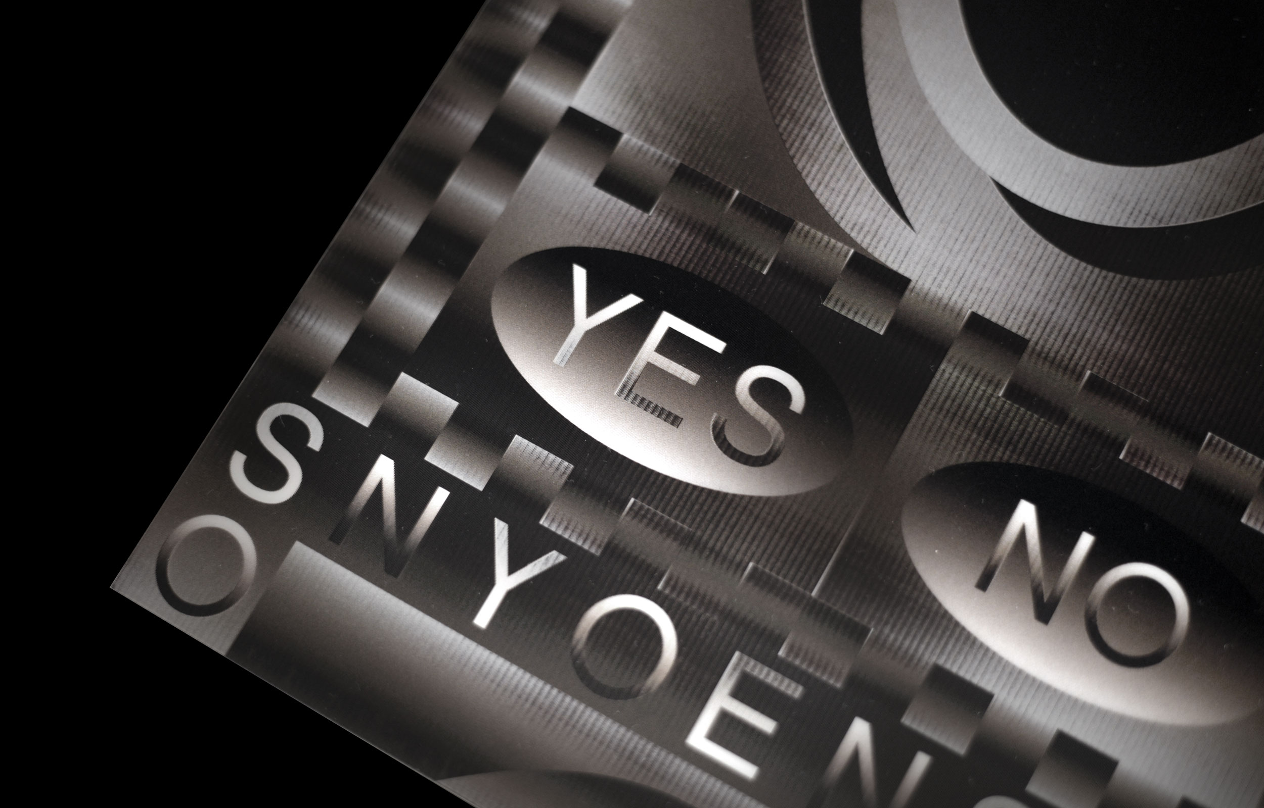 Close-up of silver YES and NO buttons over a black-and-silver checkerboard pattern