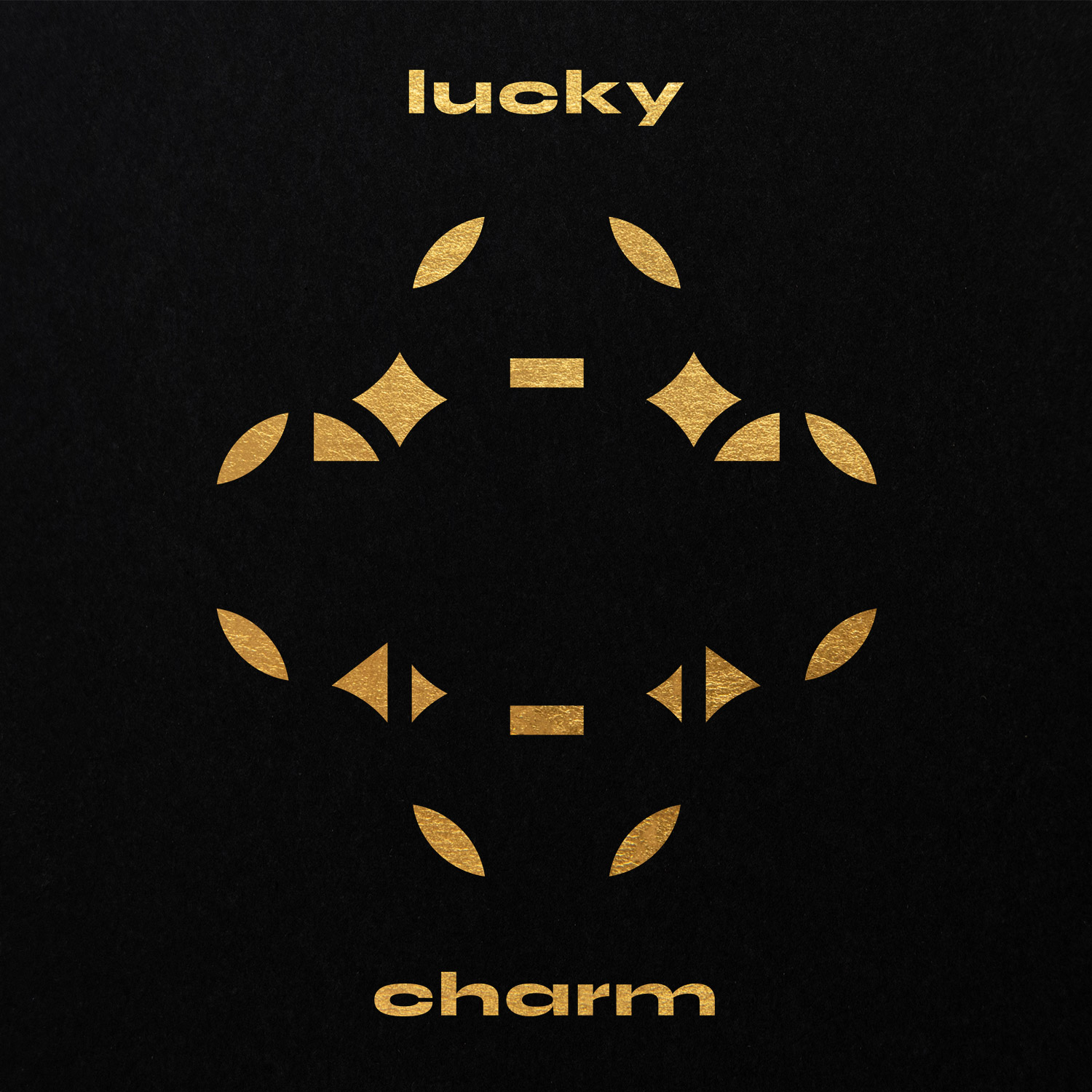 Gold diamond-and-leaf ring with Lucky Charm lettering on black