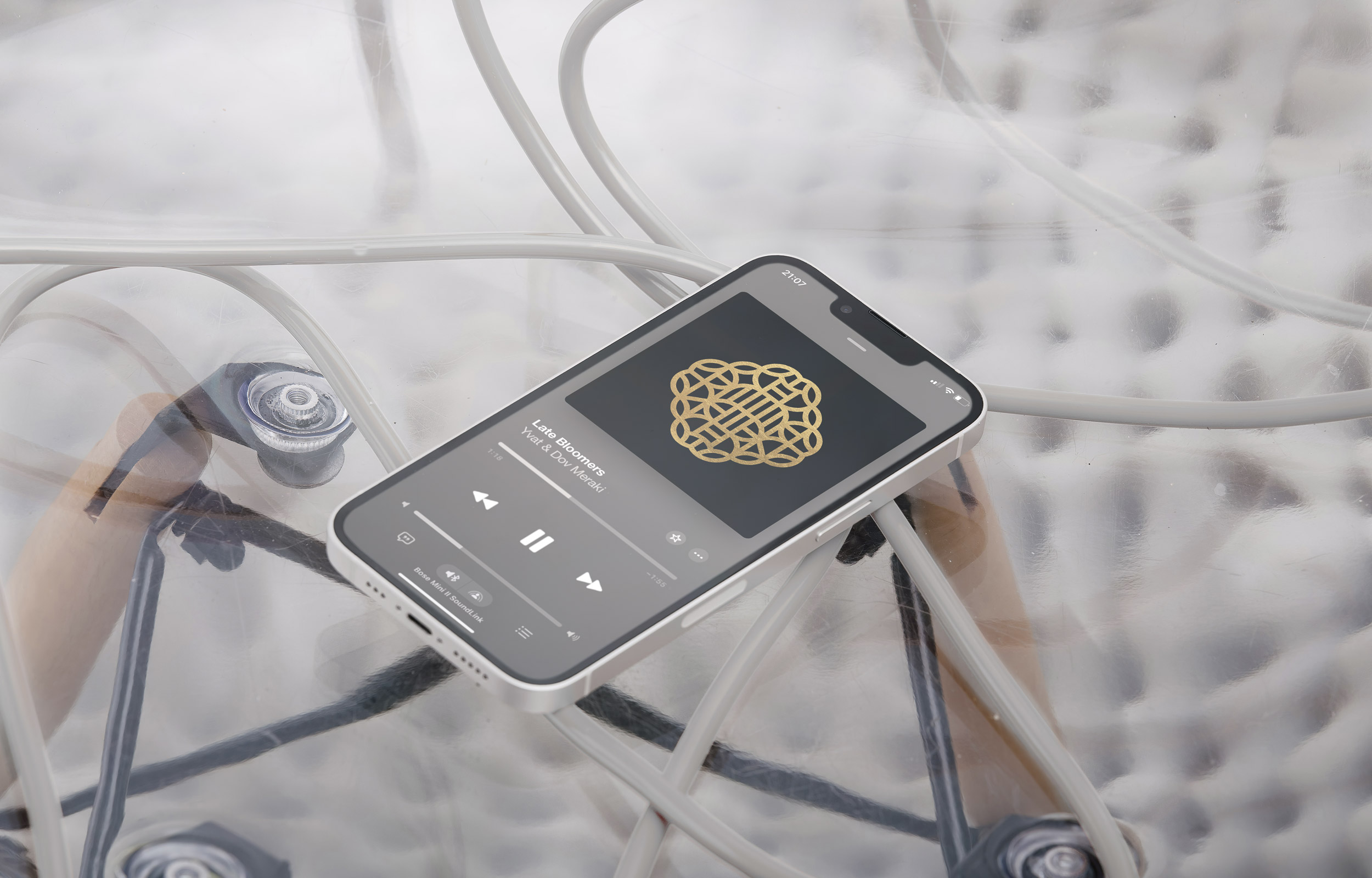 Smartphone playing music with the Golden Mind gold emblem on screen